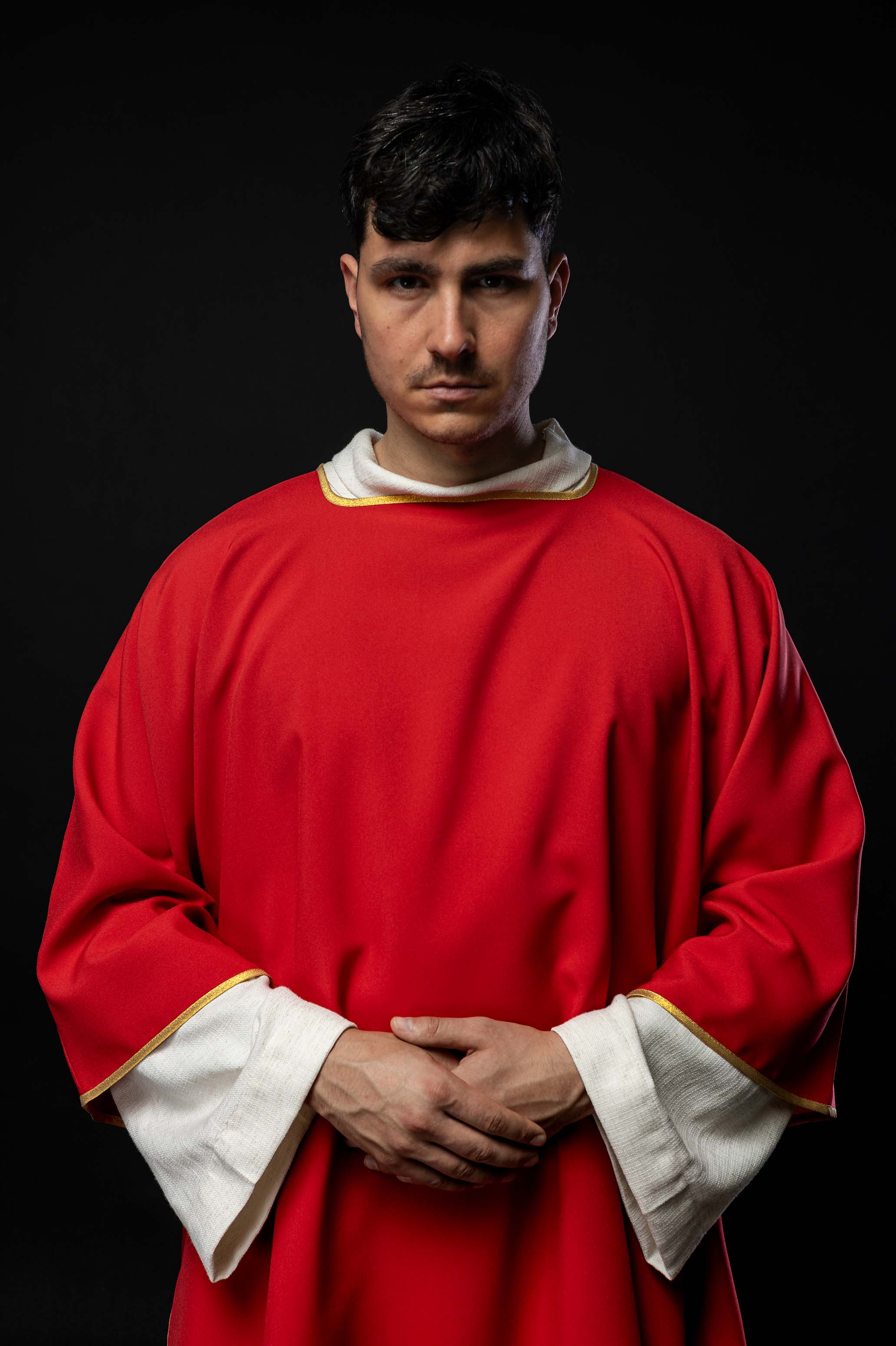 Plain dalmatic in red with gold trim