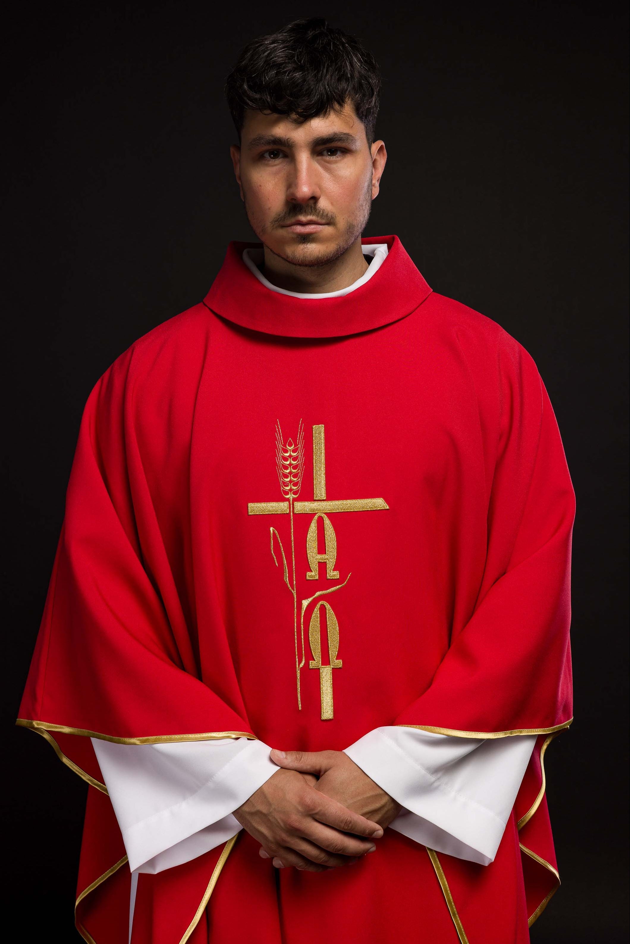 Red chasuble with cross and alfa omega symbols