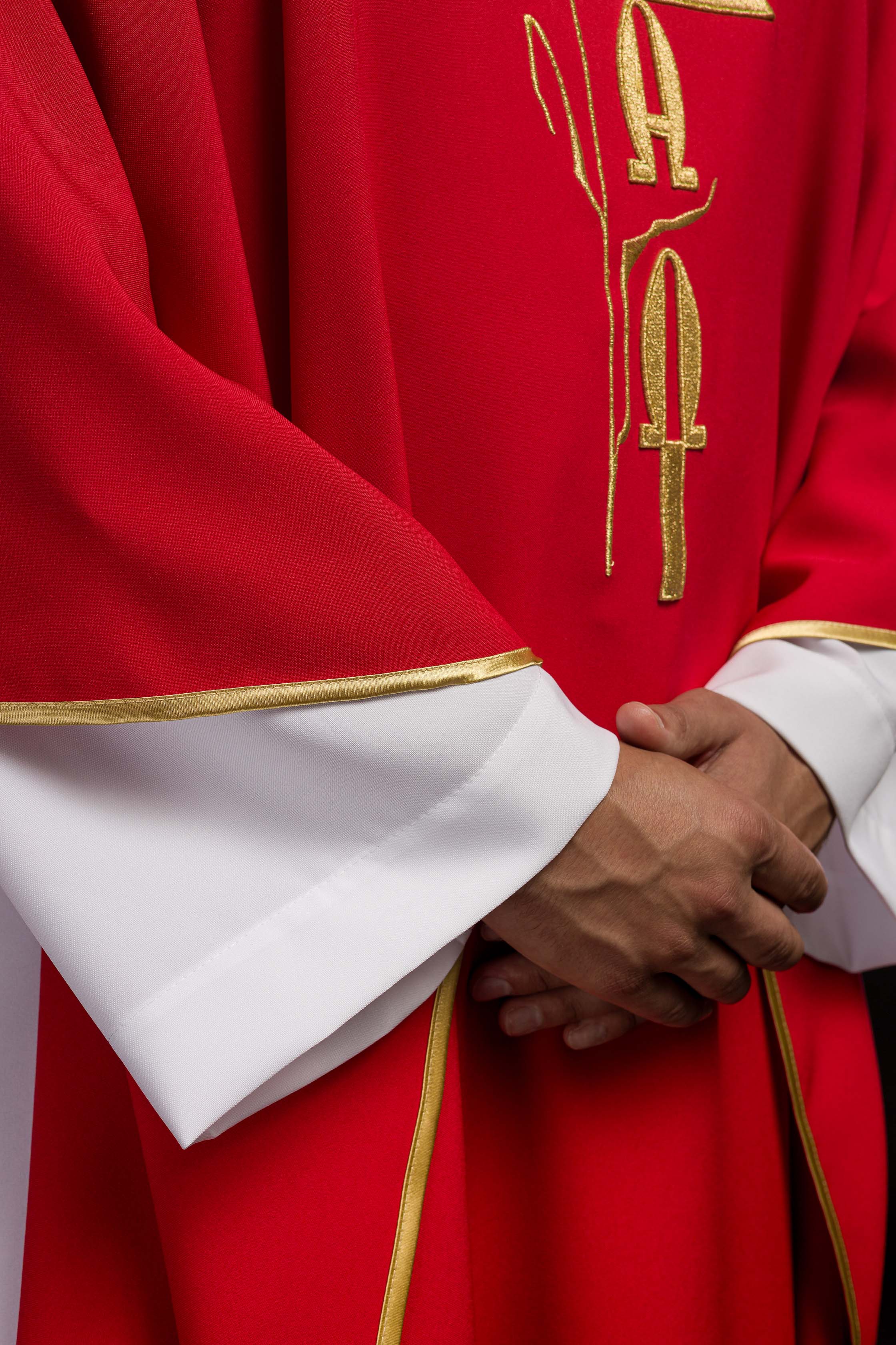 Red chasuble with cross and alfa omega symbols