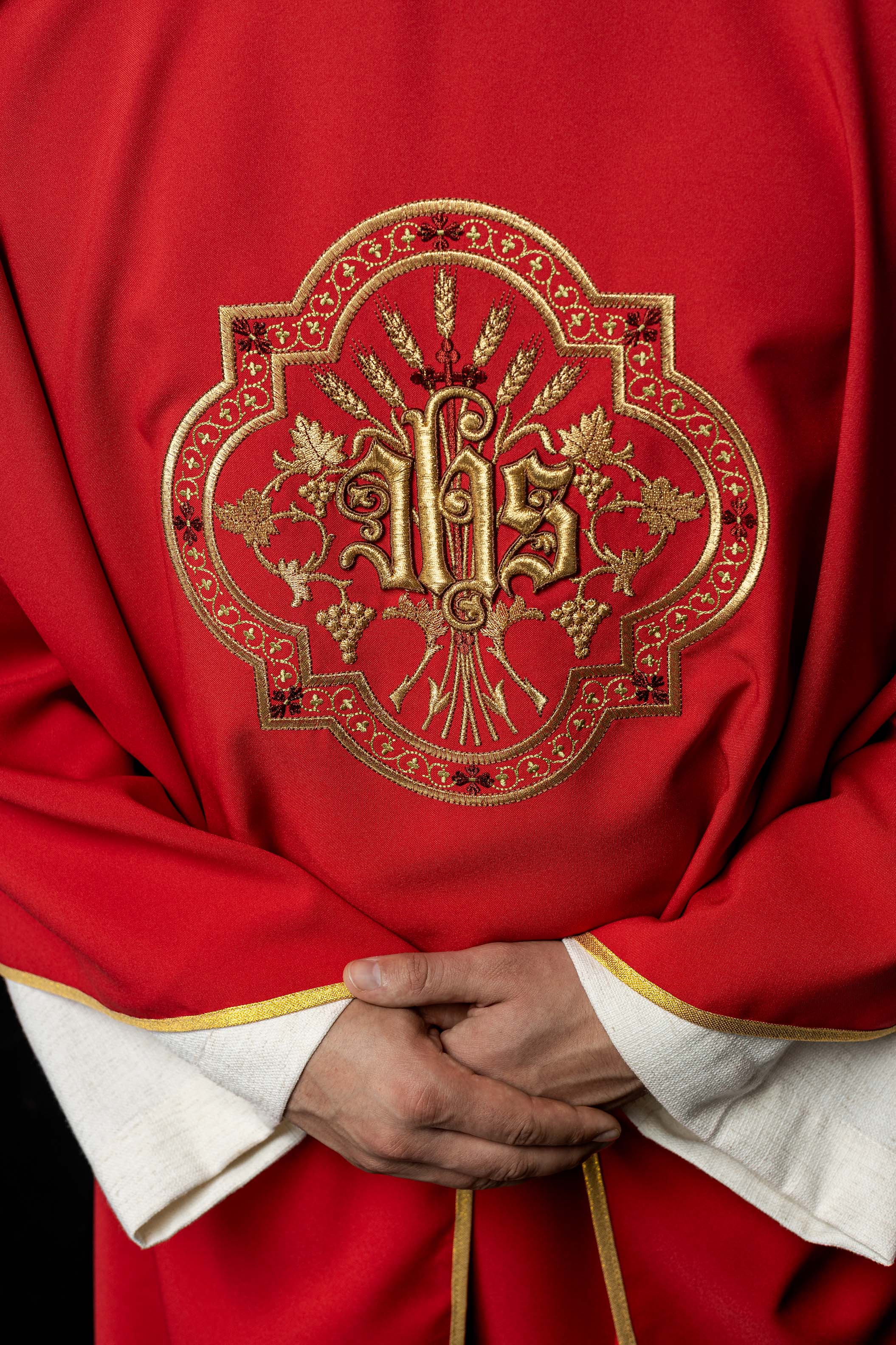 Red chasuble with IHS and PAX embroidery