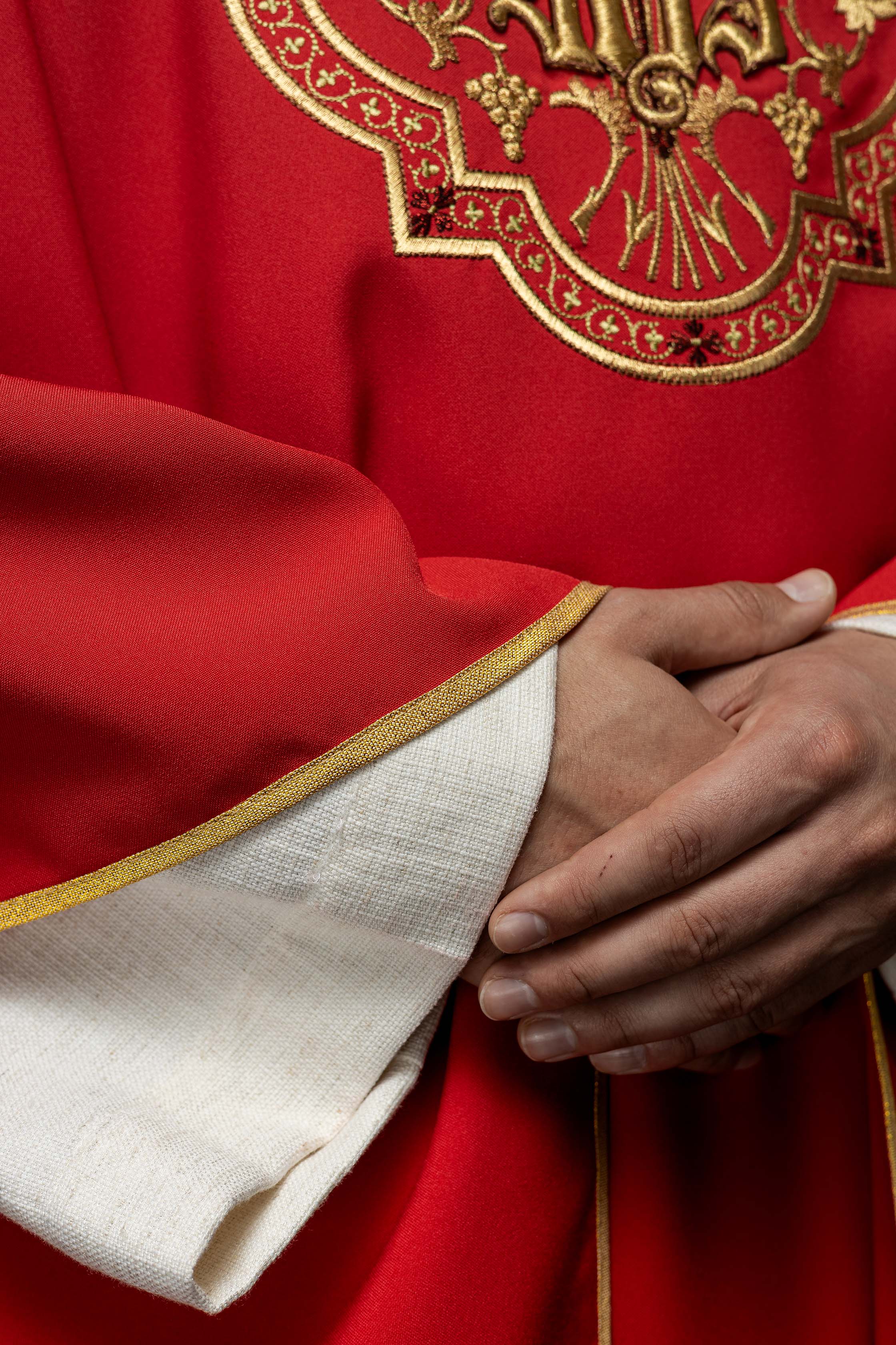 Red chasuble with IHS and PAX embroidery