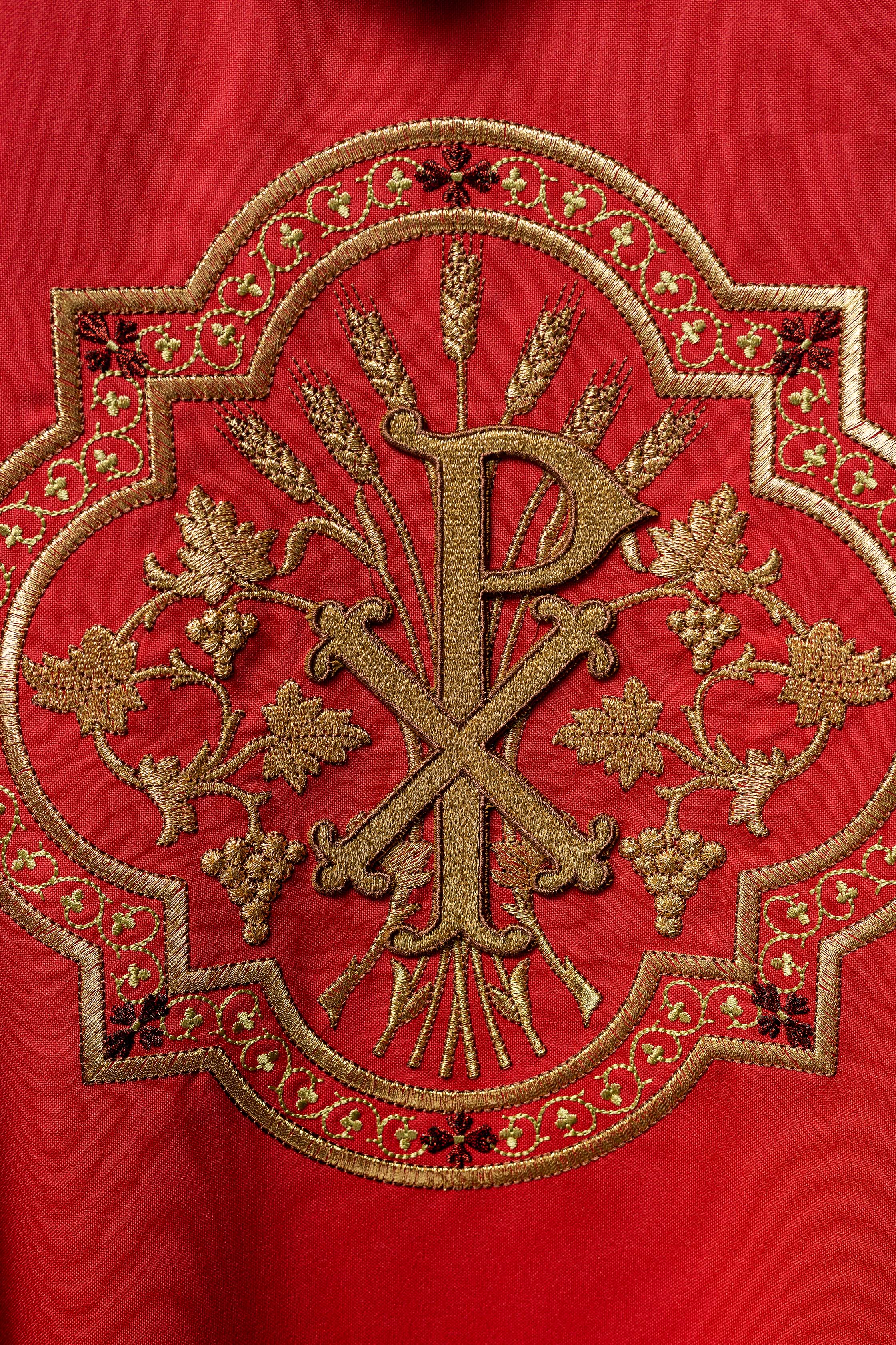 Red chasuble with IHS and PAX embroidery