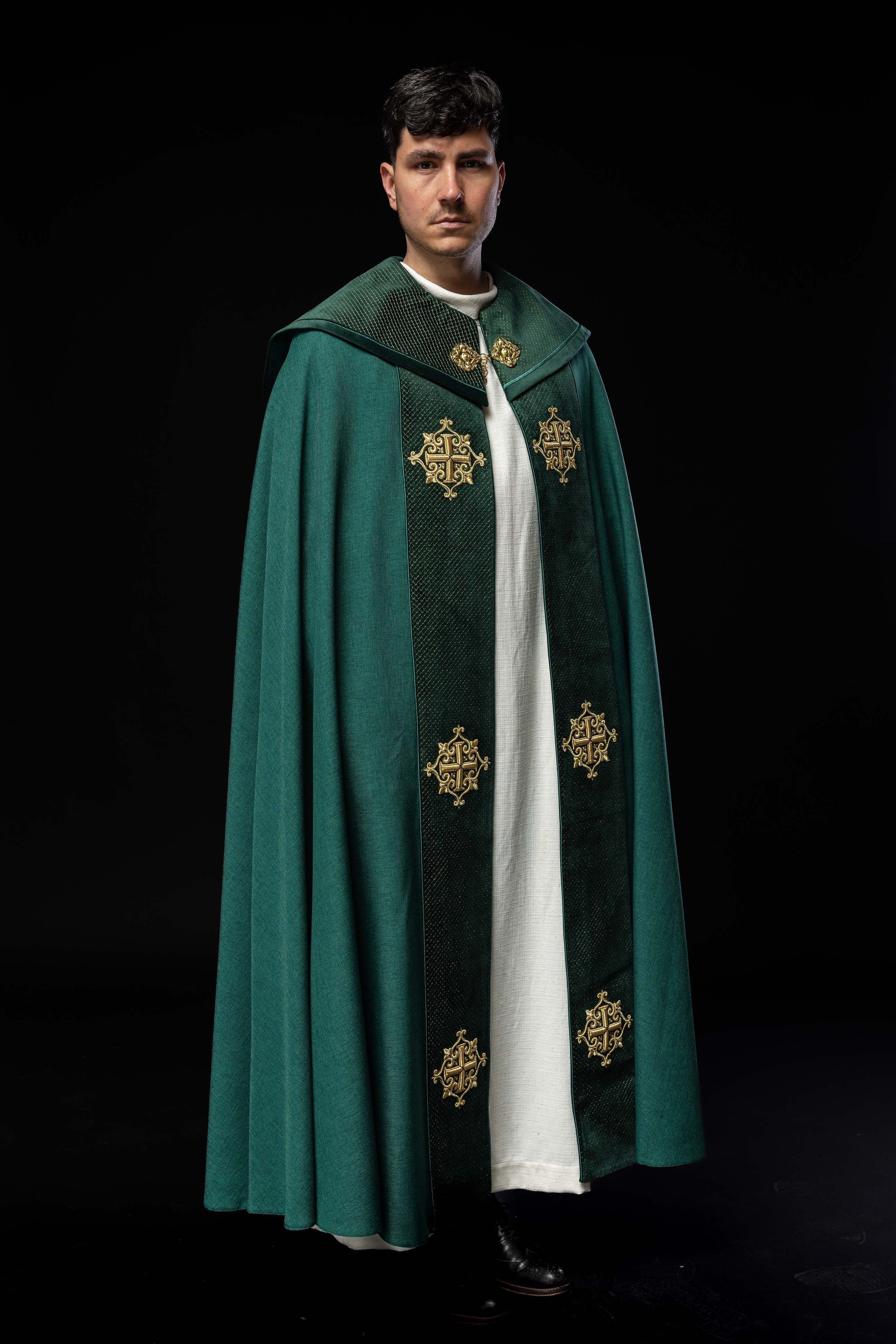 Green cope with a velvet sash and cross embroidery