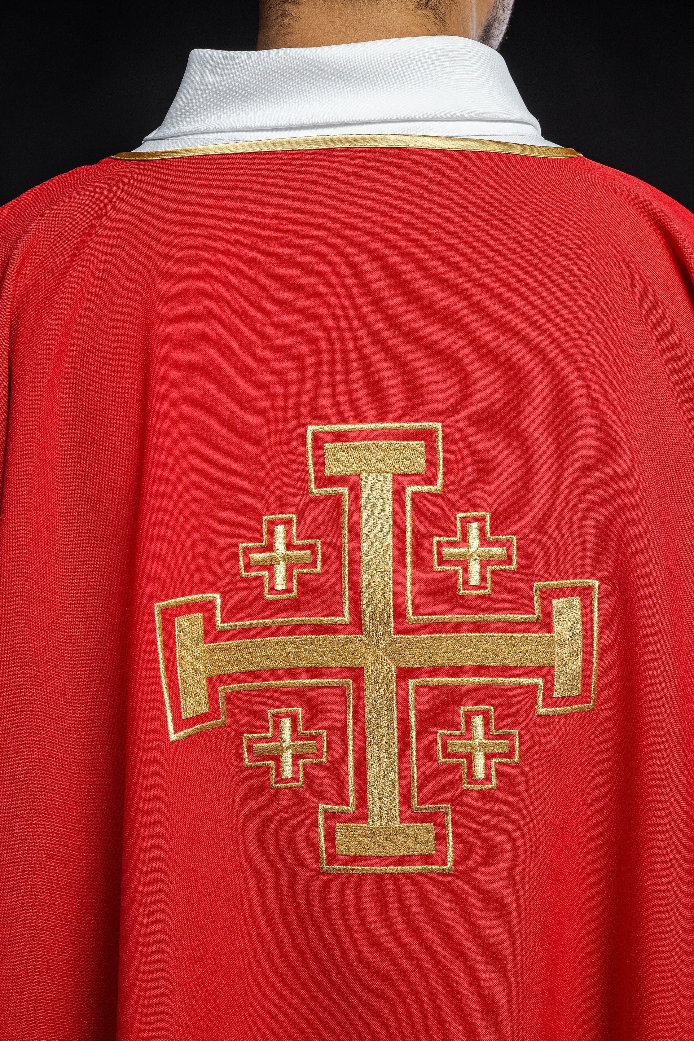 Red dalmatic priest with embroidered gold crosses