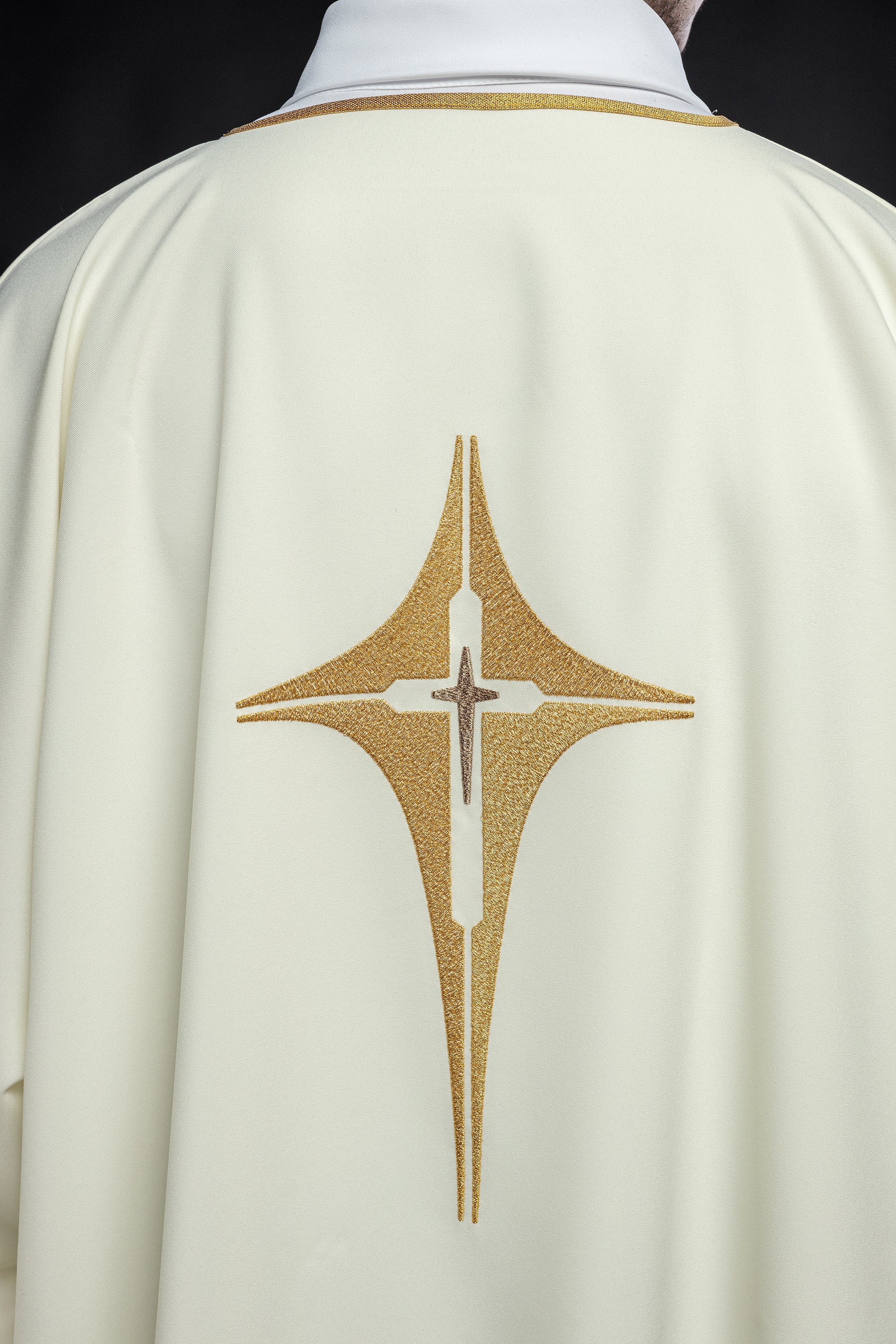 Ivory dalmatic chasuble with gold star-shaped cross