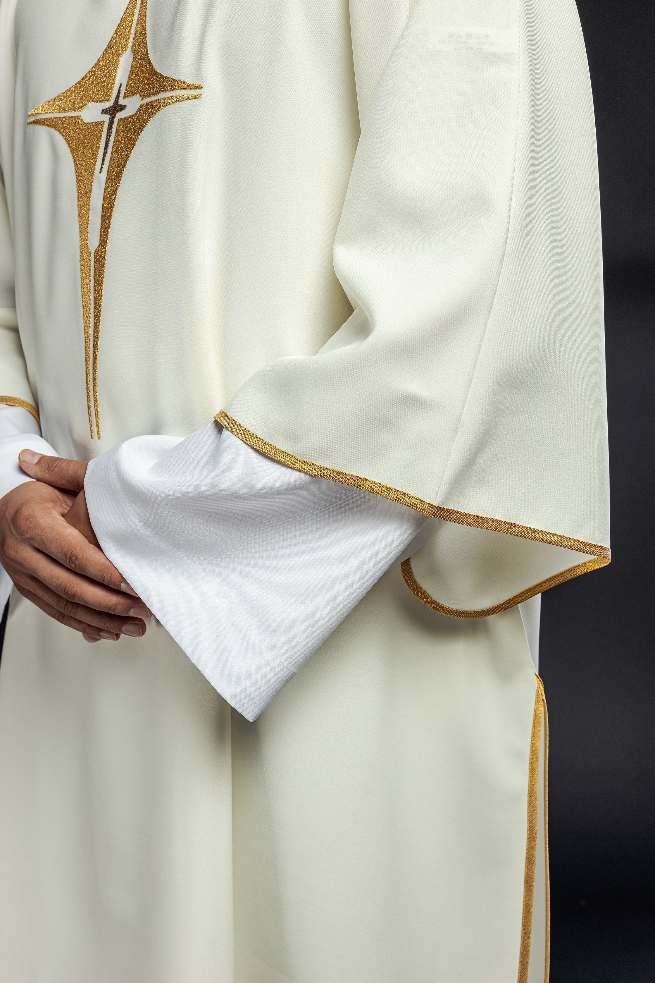 Ivory dalmatic chasuble with gold star-shaped cross