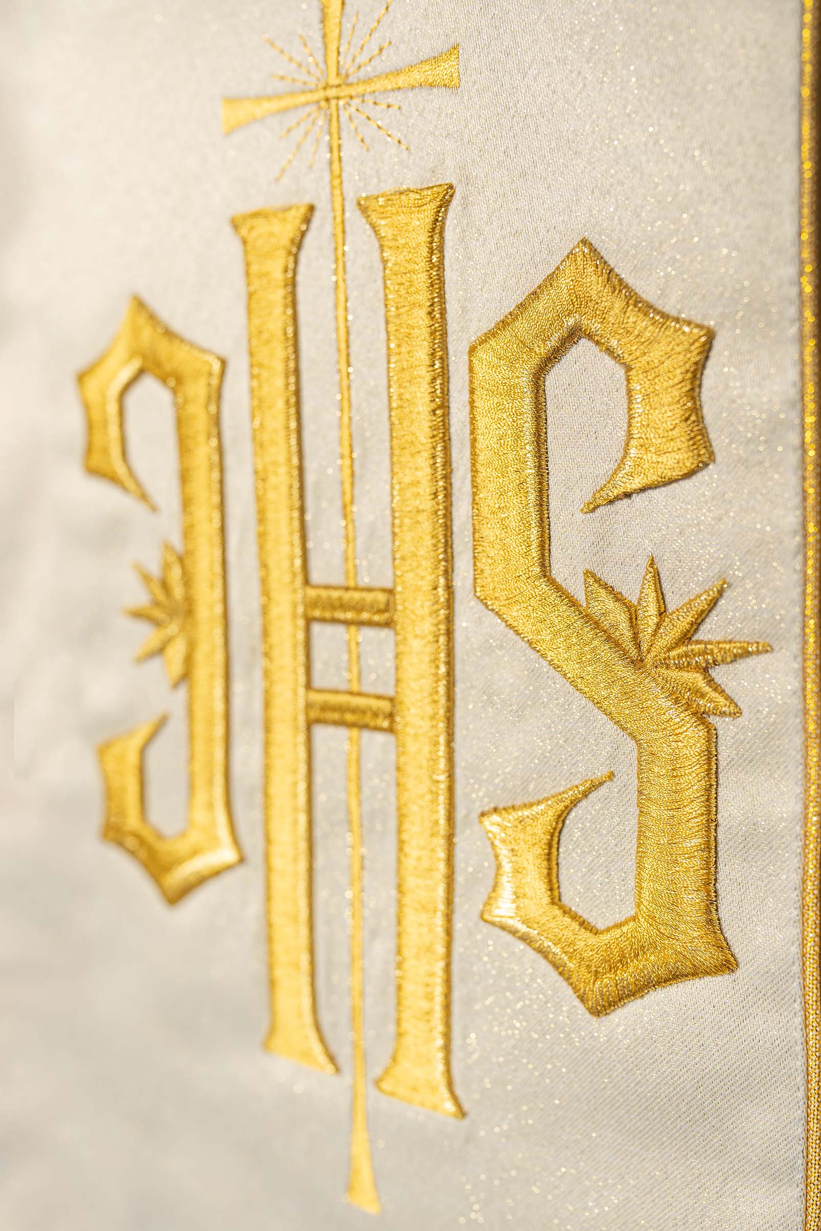 Richly decorated gold chasuble with golden motifs and a wide IHS band