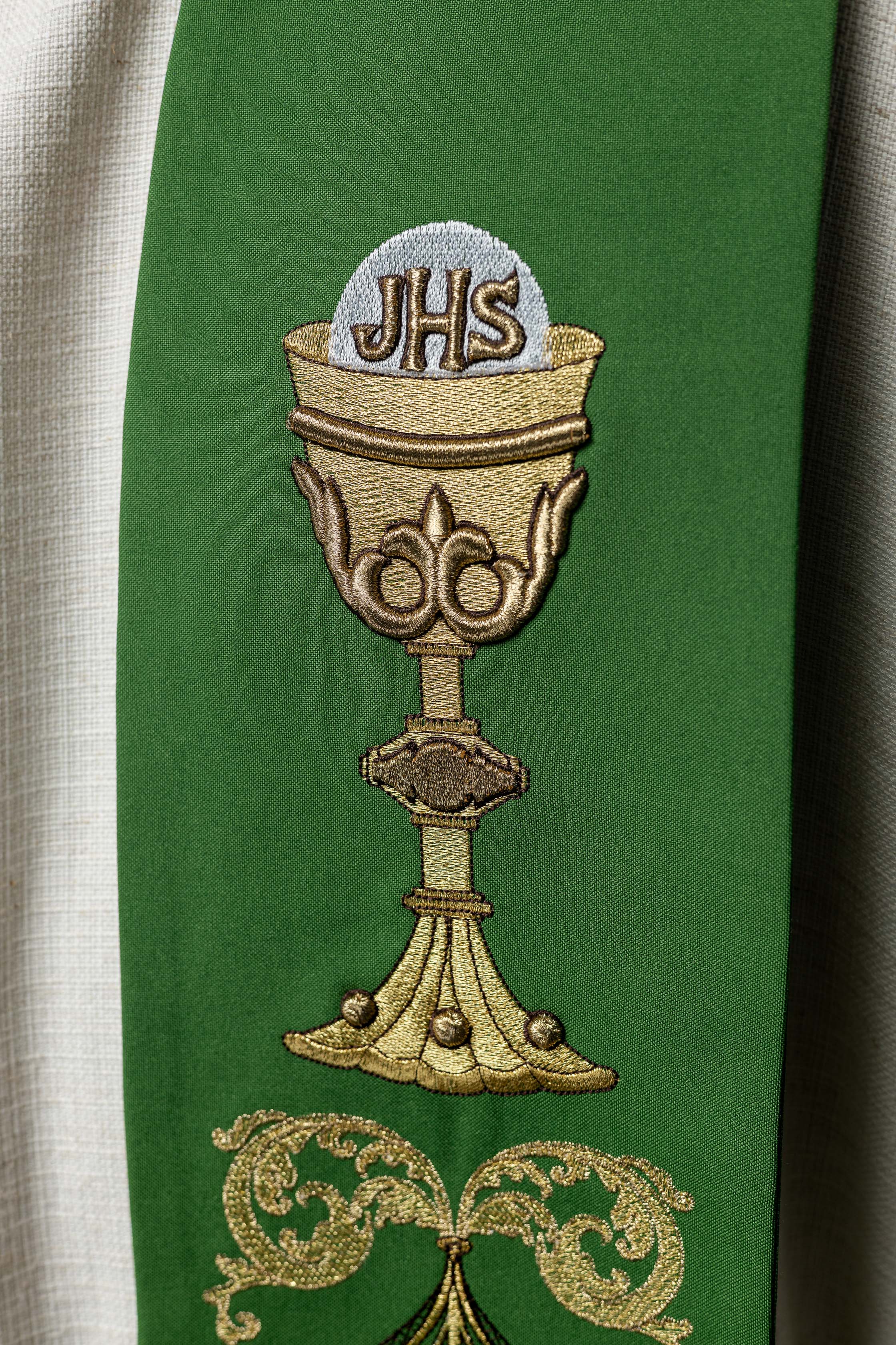 Green priestly stole with IHS chalice