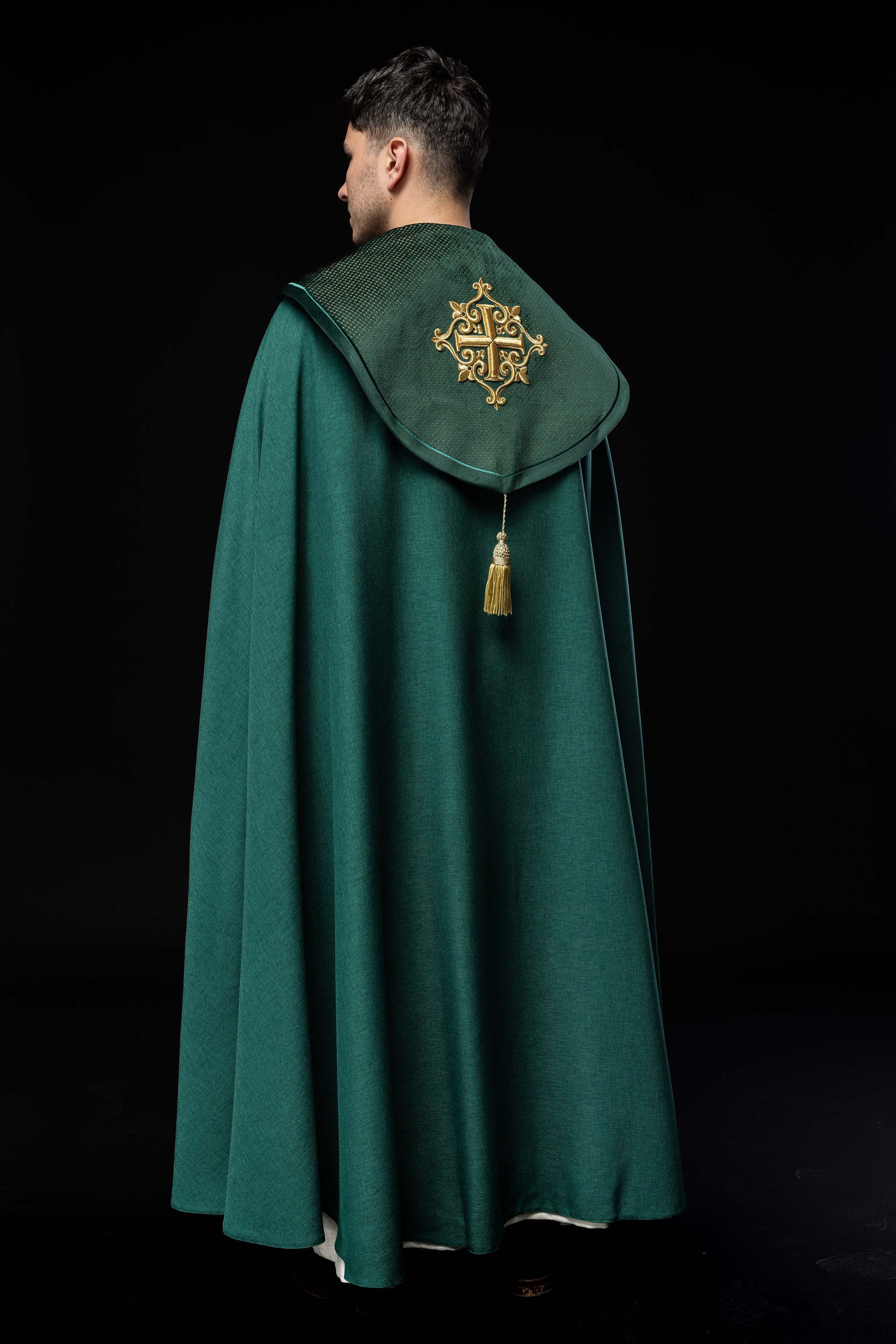 Green cope with a velvet sash and cross embroidery