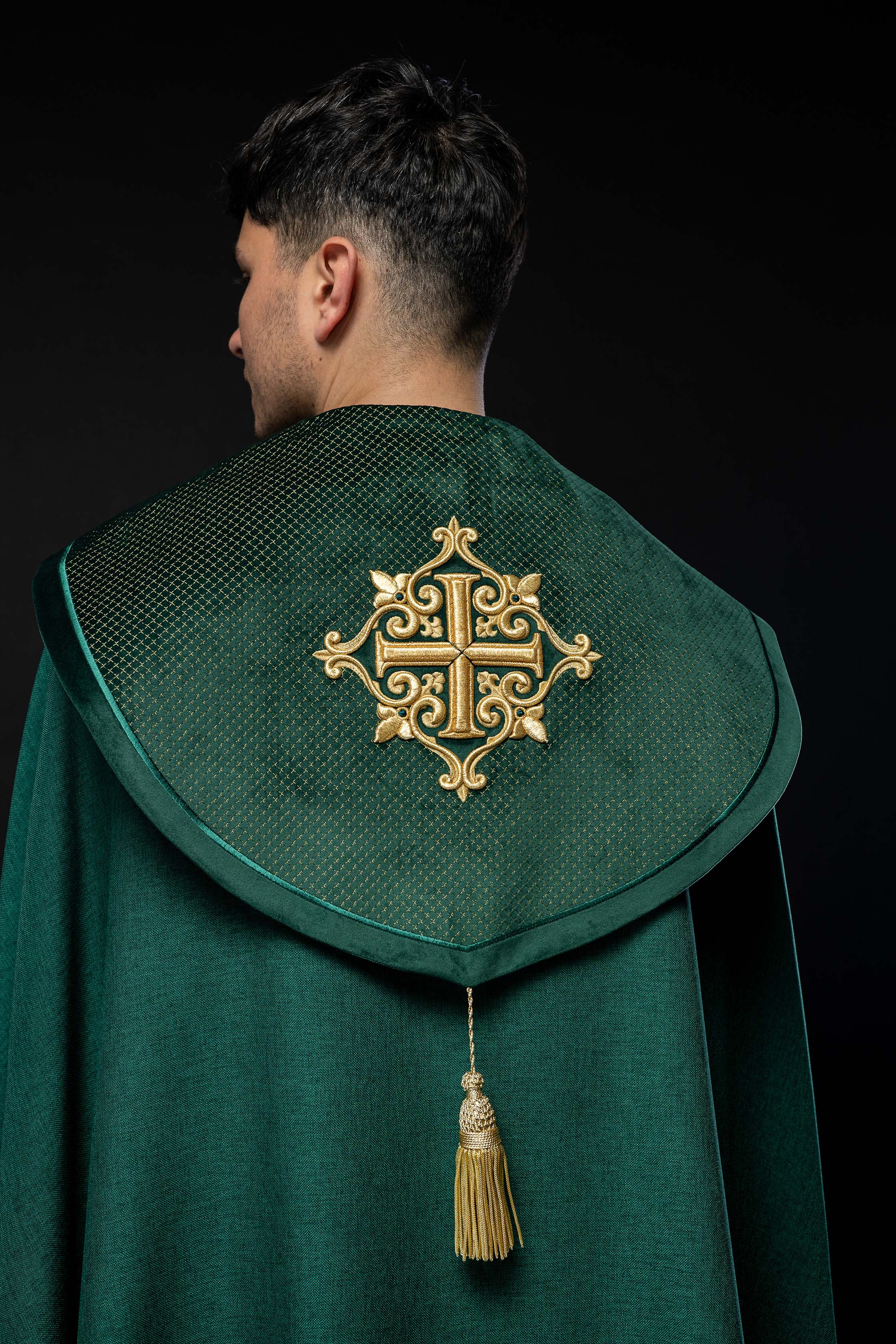 Green cope with a velvet sash and cross embroidery