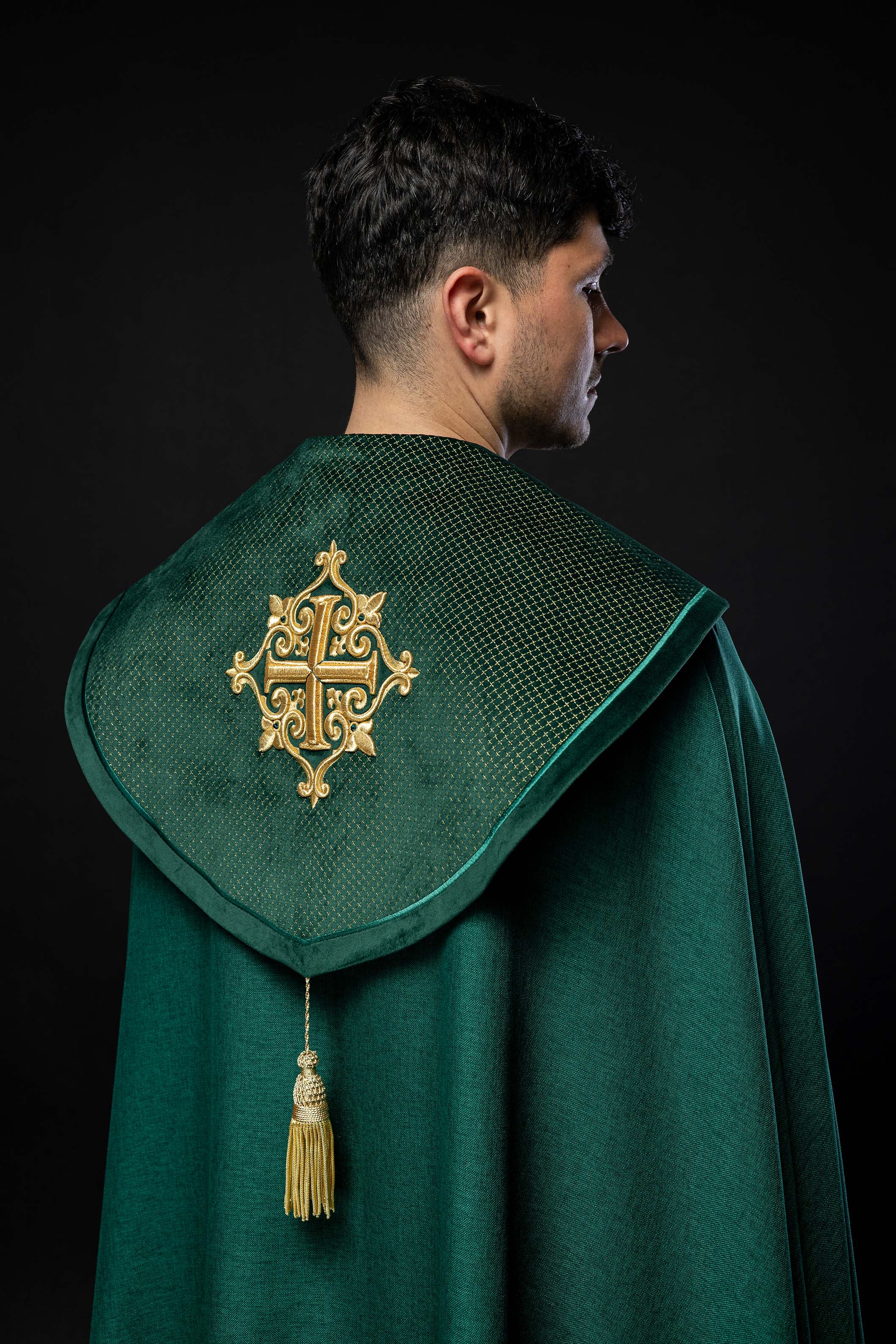 Green cope with a velvet sash and cross embroidery