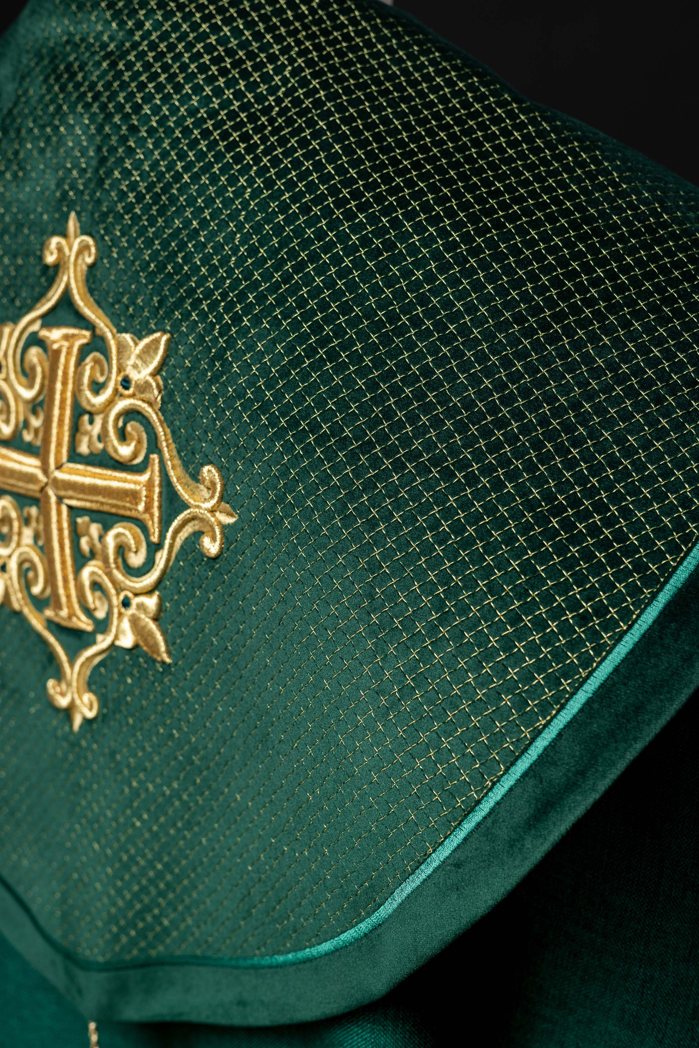 Green cope with a velvet sash and cross embroidery