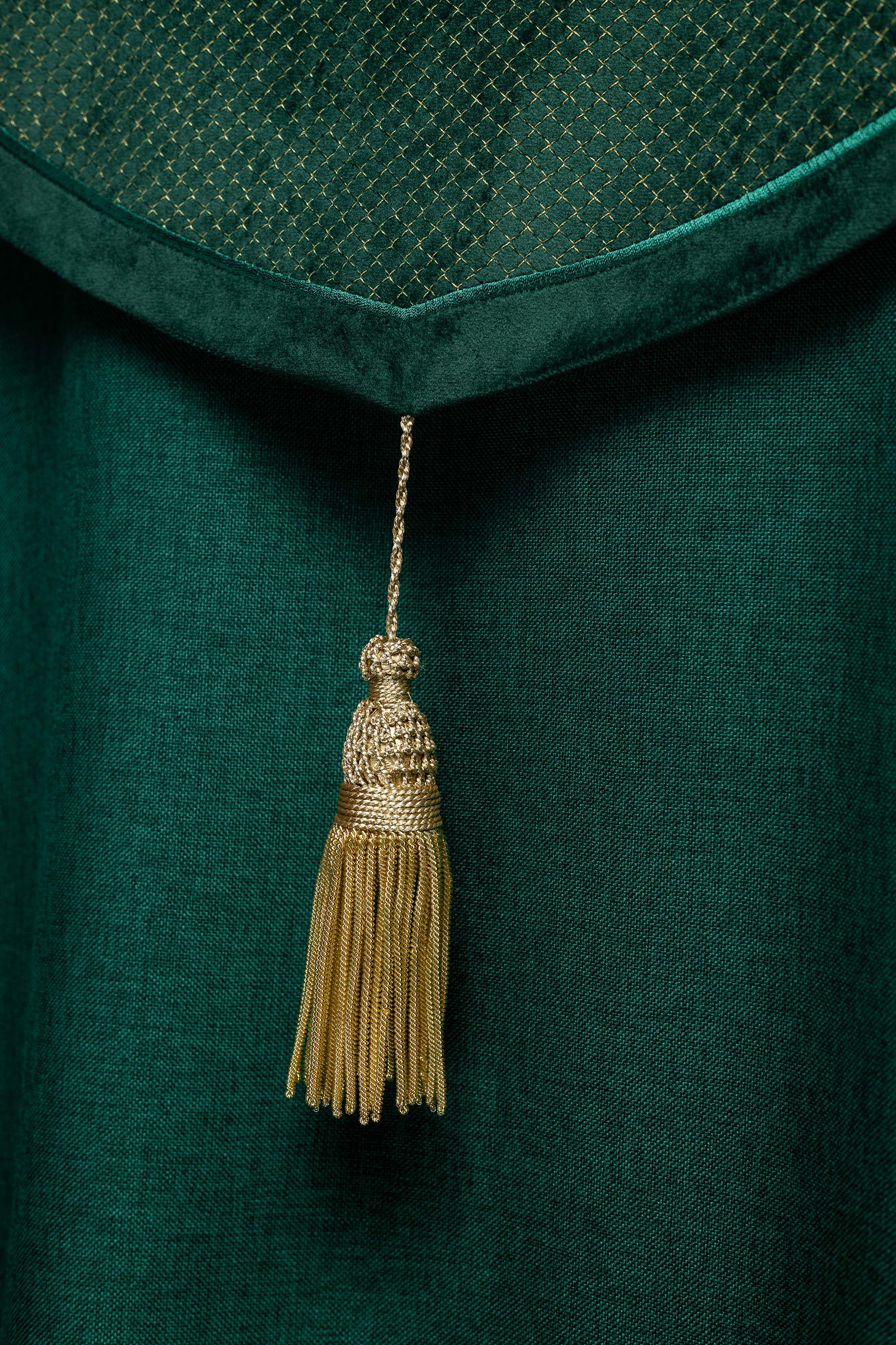Green cope with a velvet sash and cross embroidery