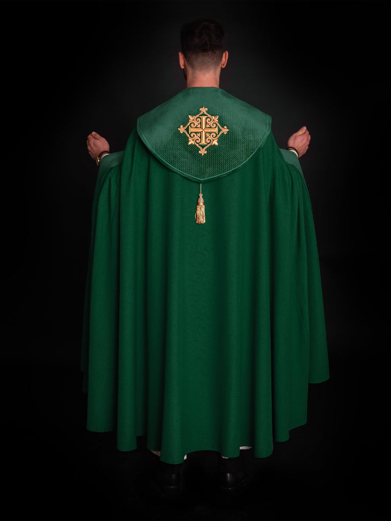 Green cope with a velvet sash and cross embroidery