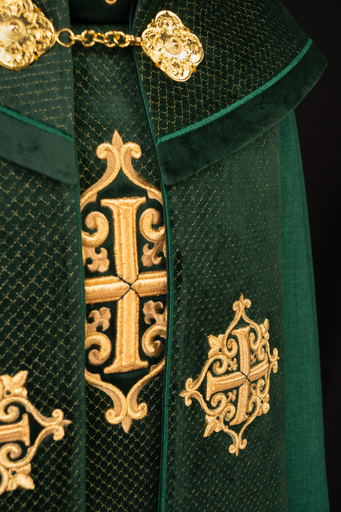 Green cope with a velvet sash and cross embroidery