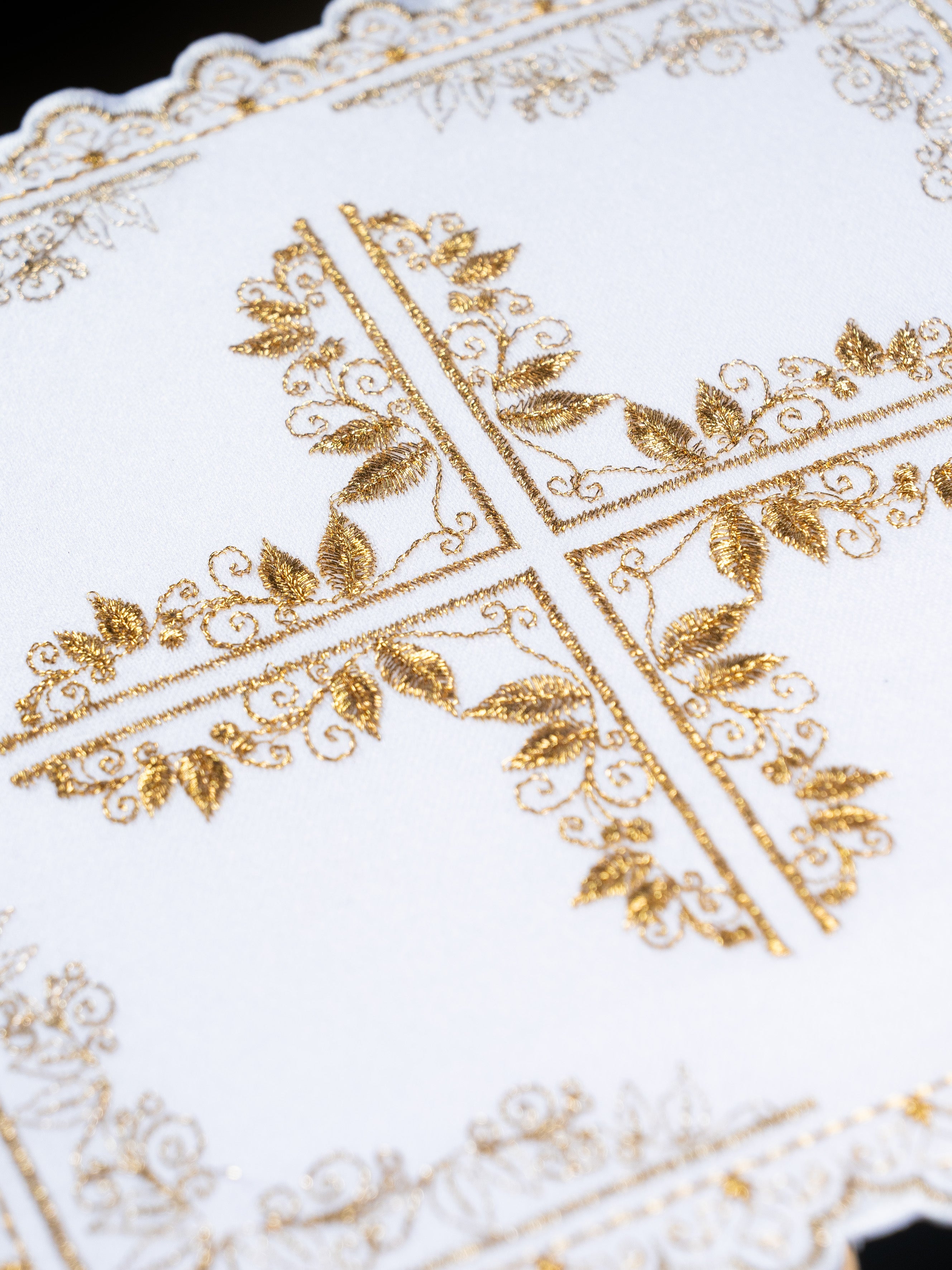 Mass linen set with cross motif framed by floral embroidery