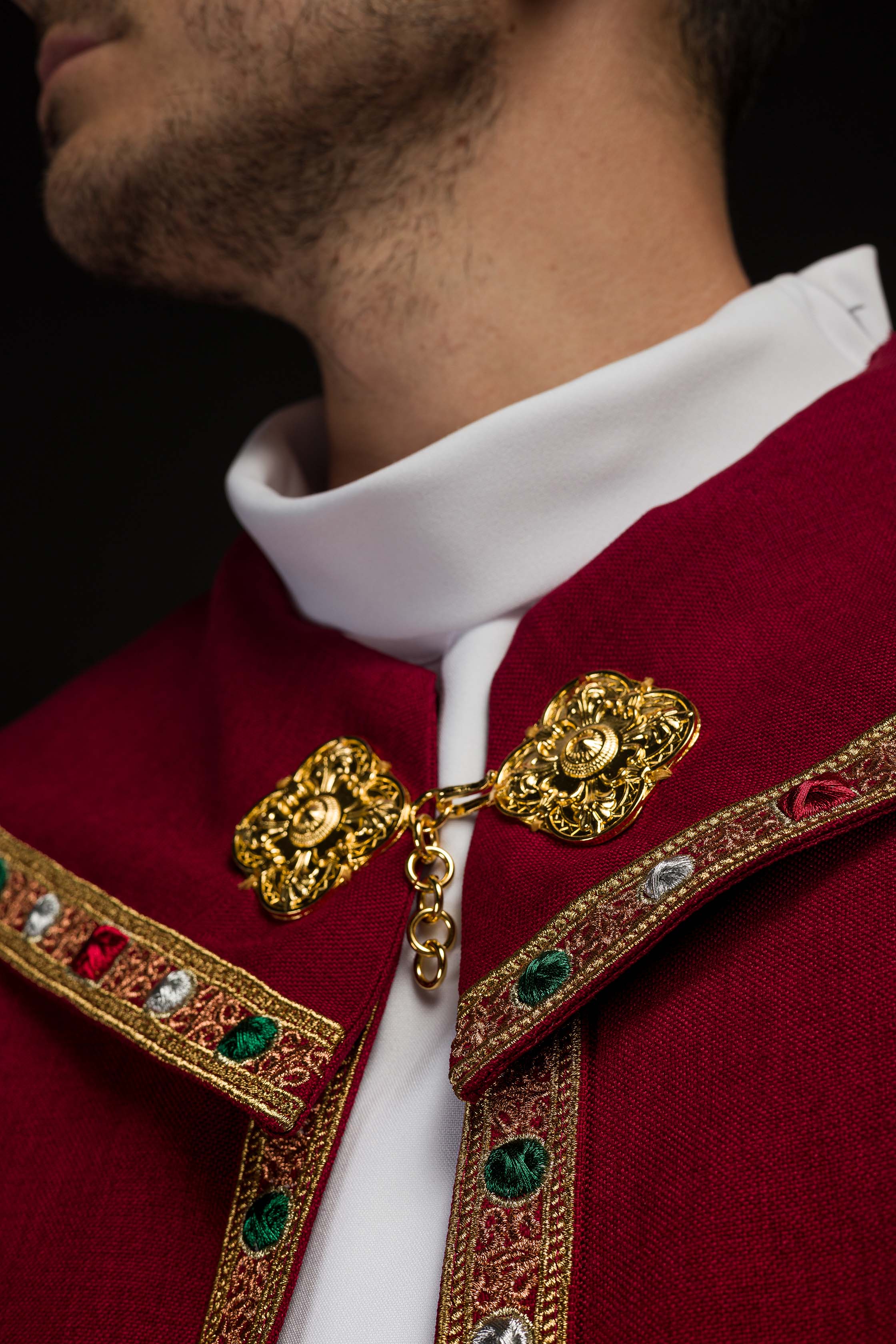 Liturgical cope in red finished with JHS embroidery