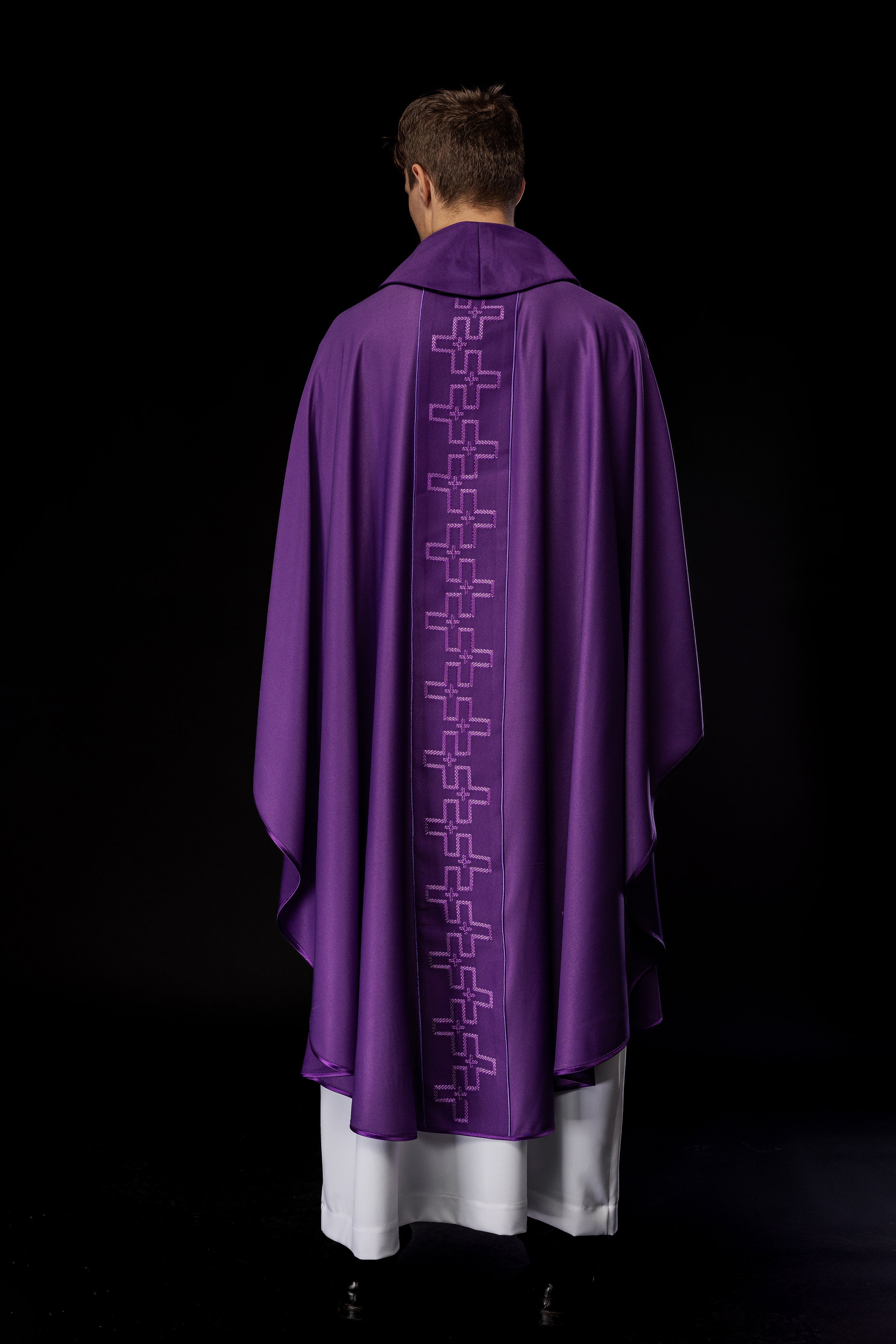 Chasuble with richly embroidered orphrey in embroidery of crosses in purple color