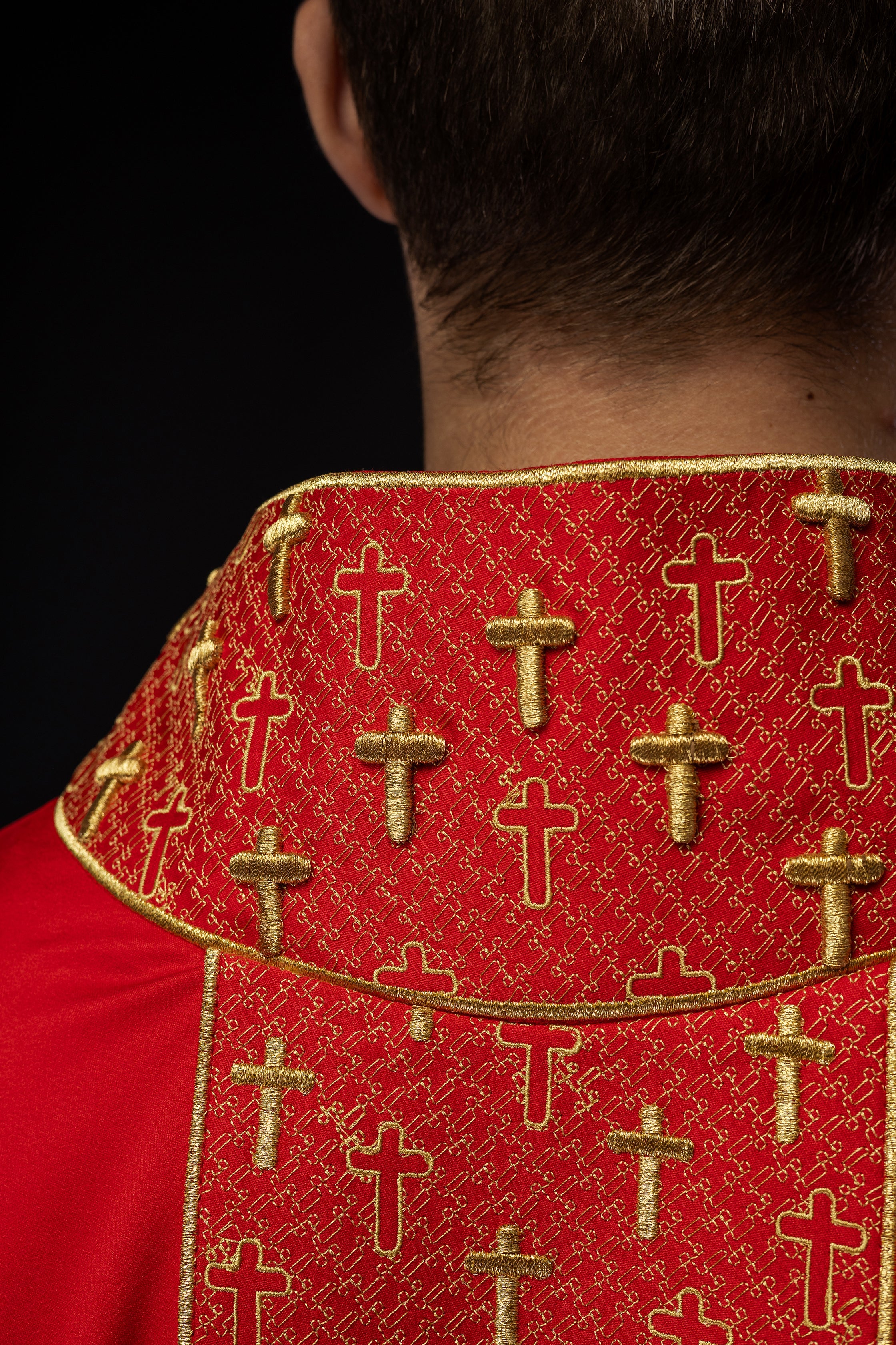 Red chasuble with gold cross embroidery on wide orphrey and collar