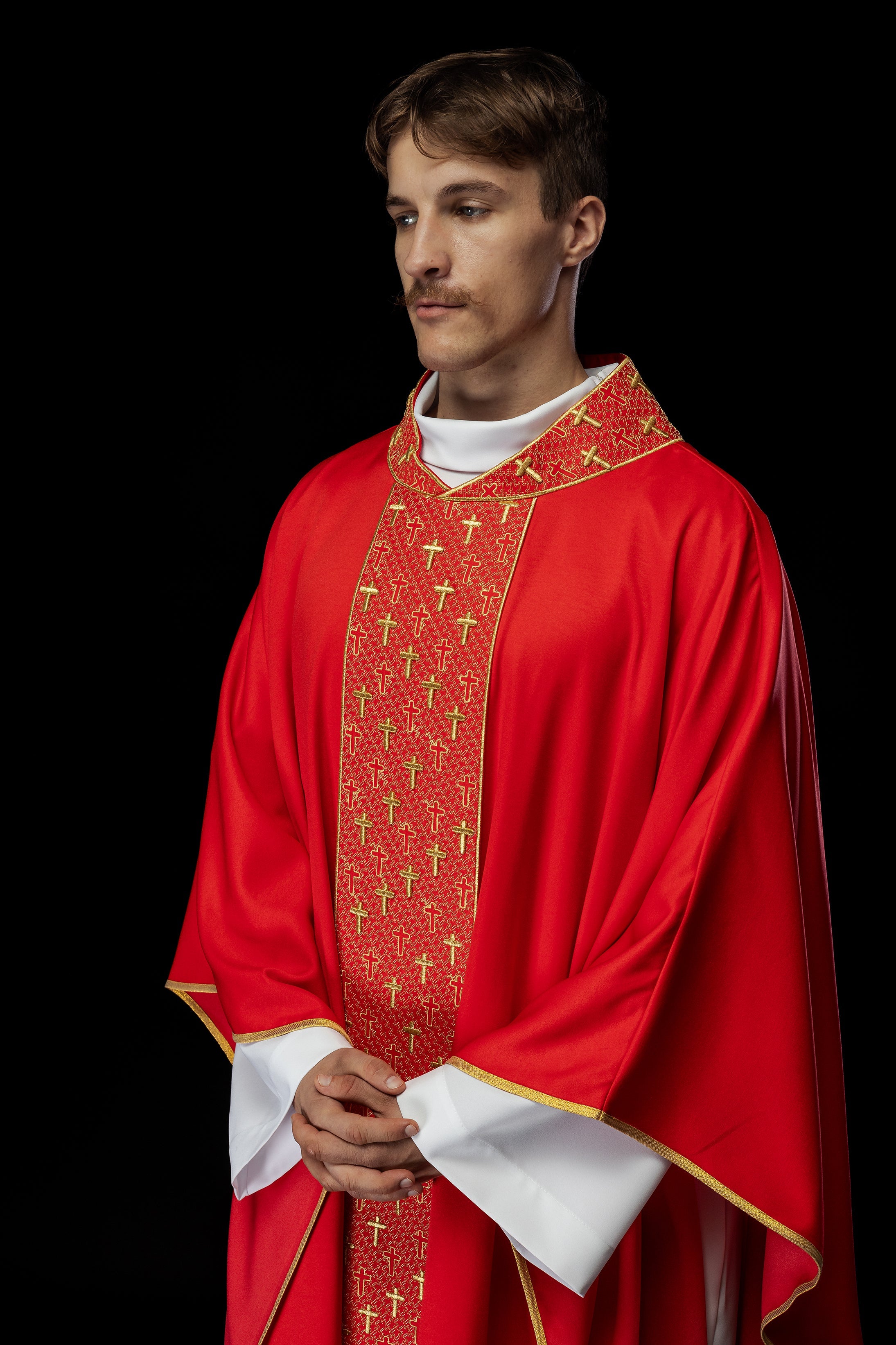 Red chasuble with gold cross embroidery on wide orphrey and collar