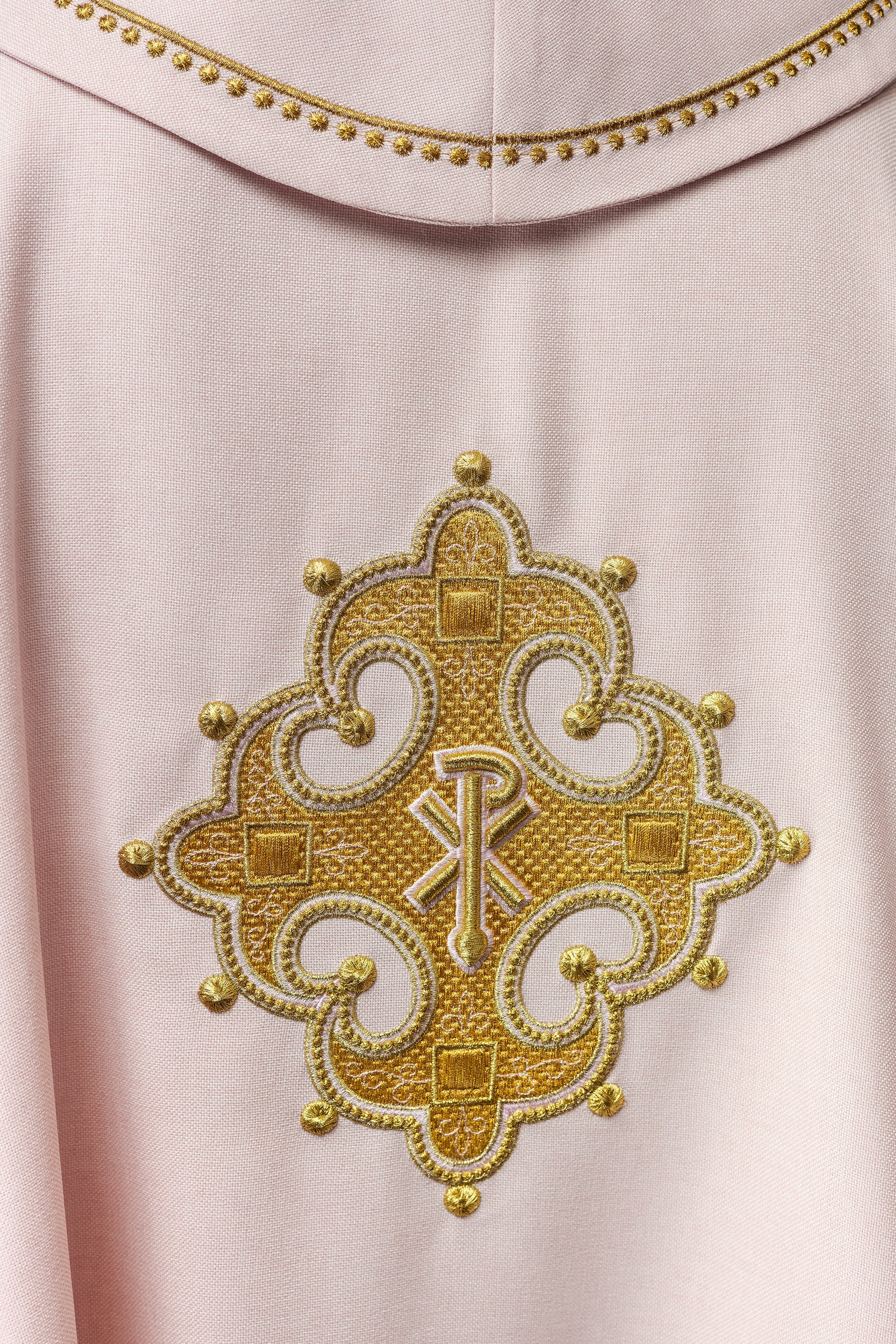 Simple pink chasuble with small PAX motif embroidery