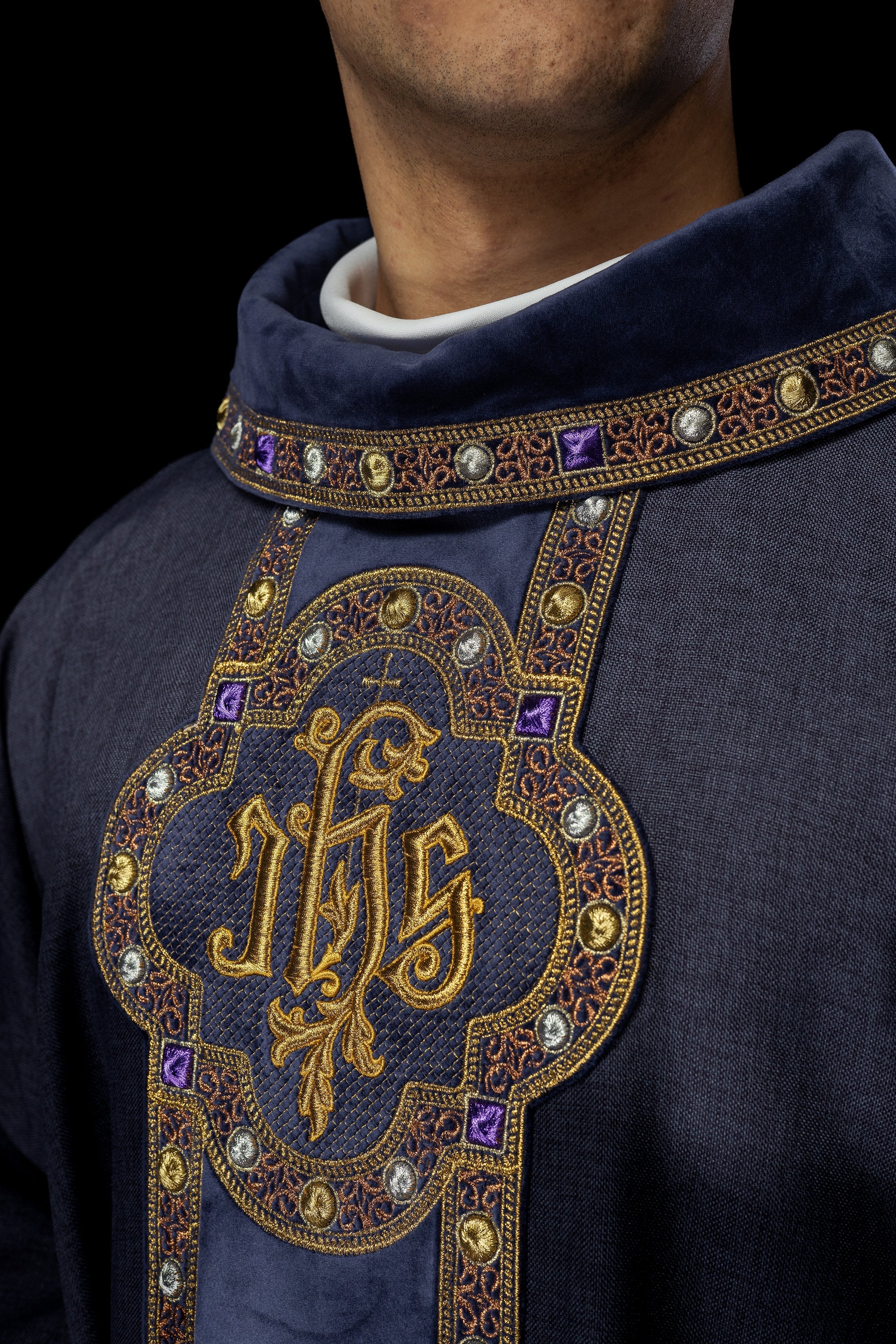 Chasuble with richly embroidered orphrey and piping around the IHS I collar embroidery in purple