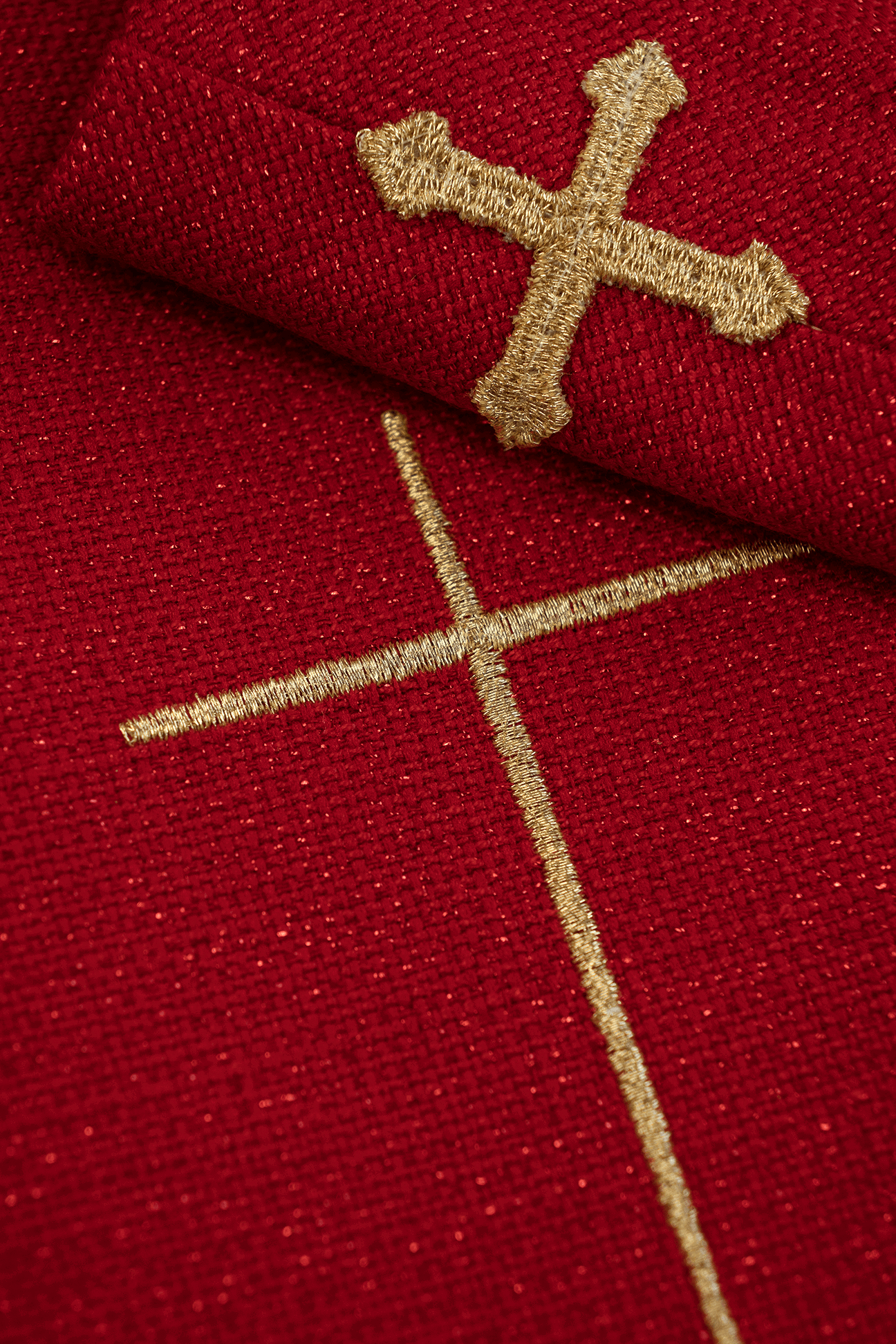 Shiny, richly embroidered red chasuble