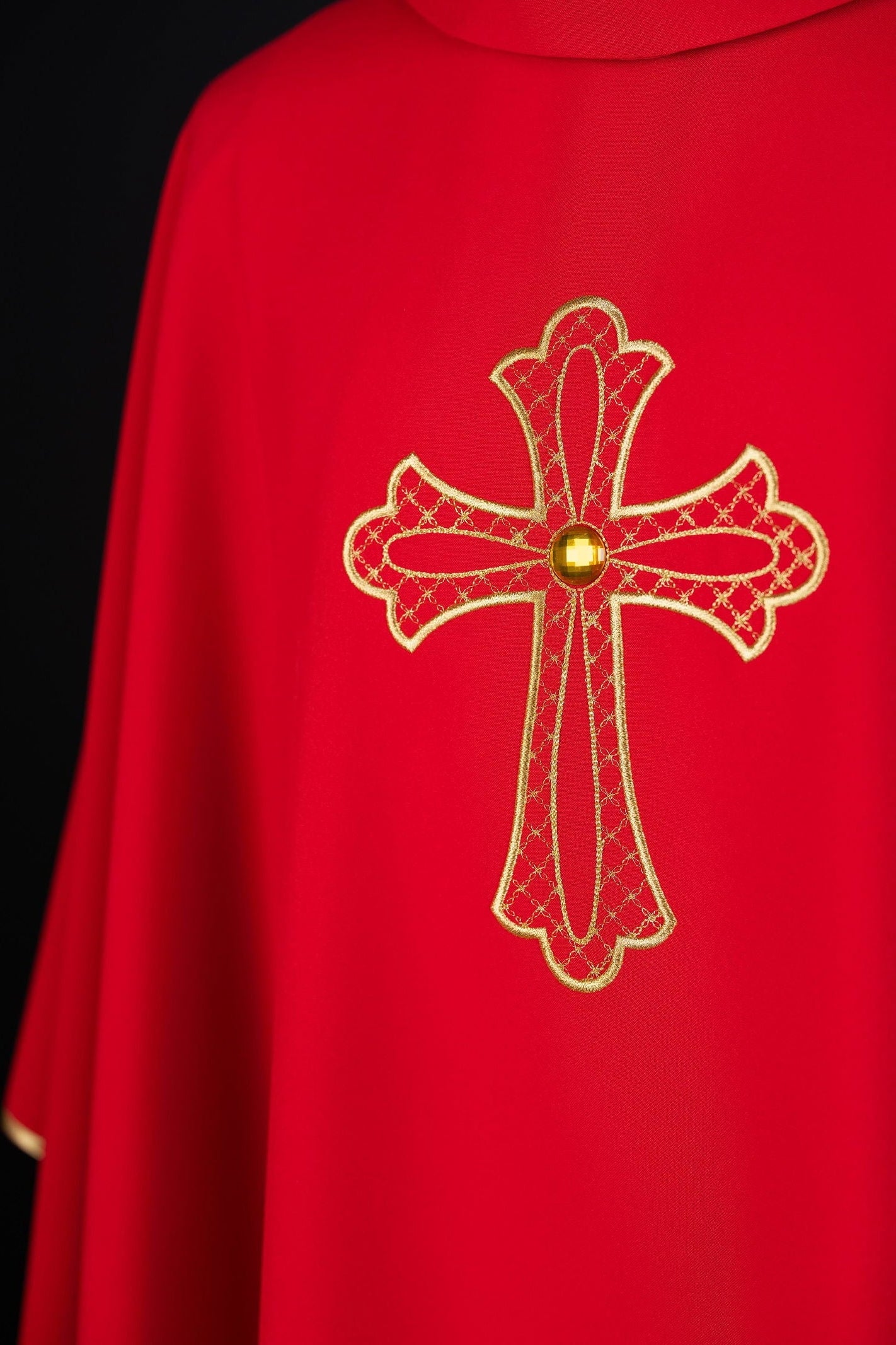 Red chasuble embroidered with the symbol of the cros