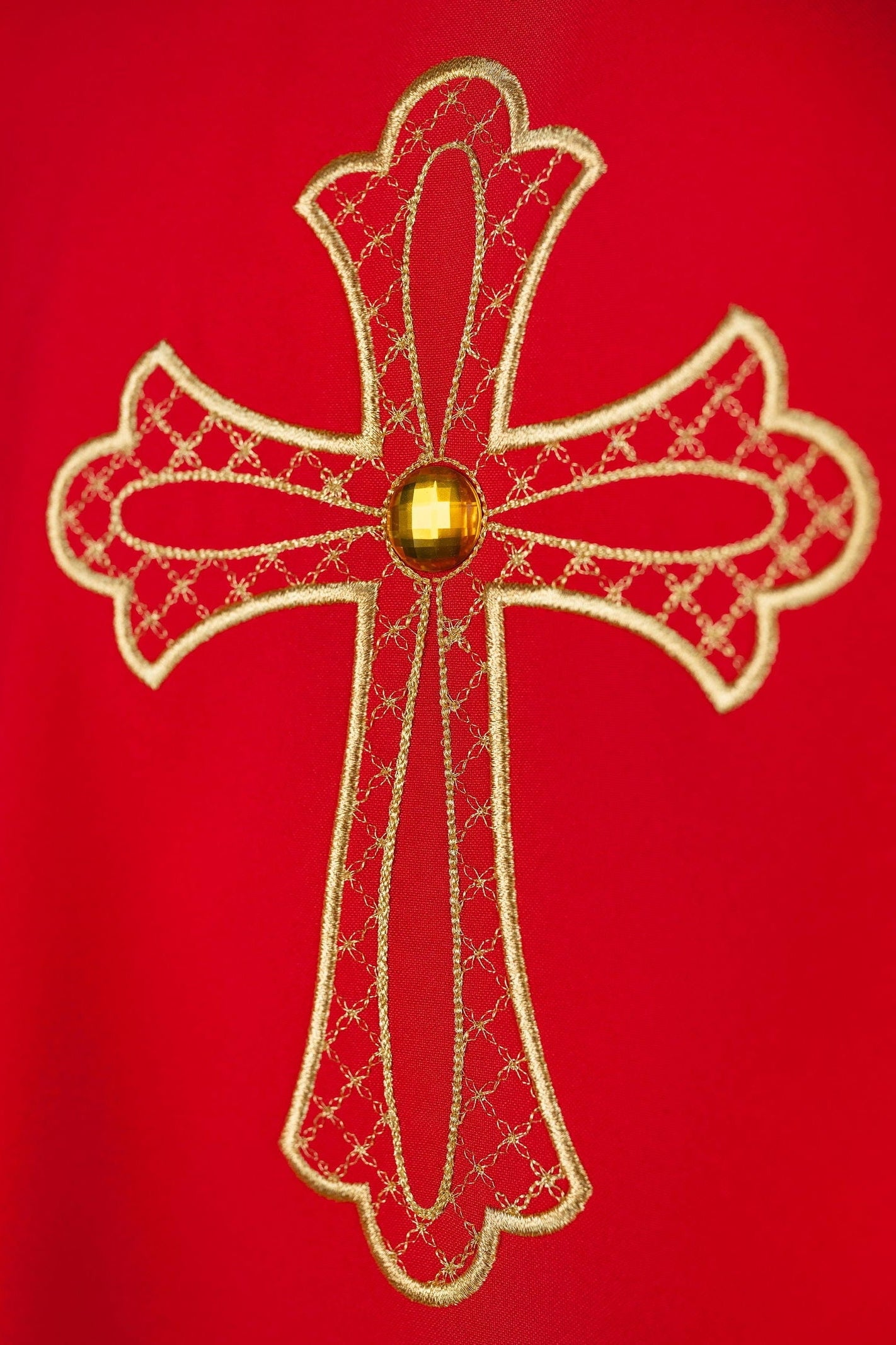 Red chasuble embroidered with the symbol of the cros