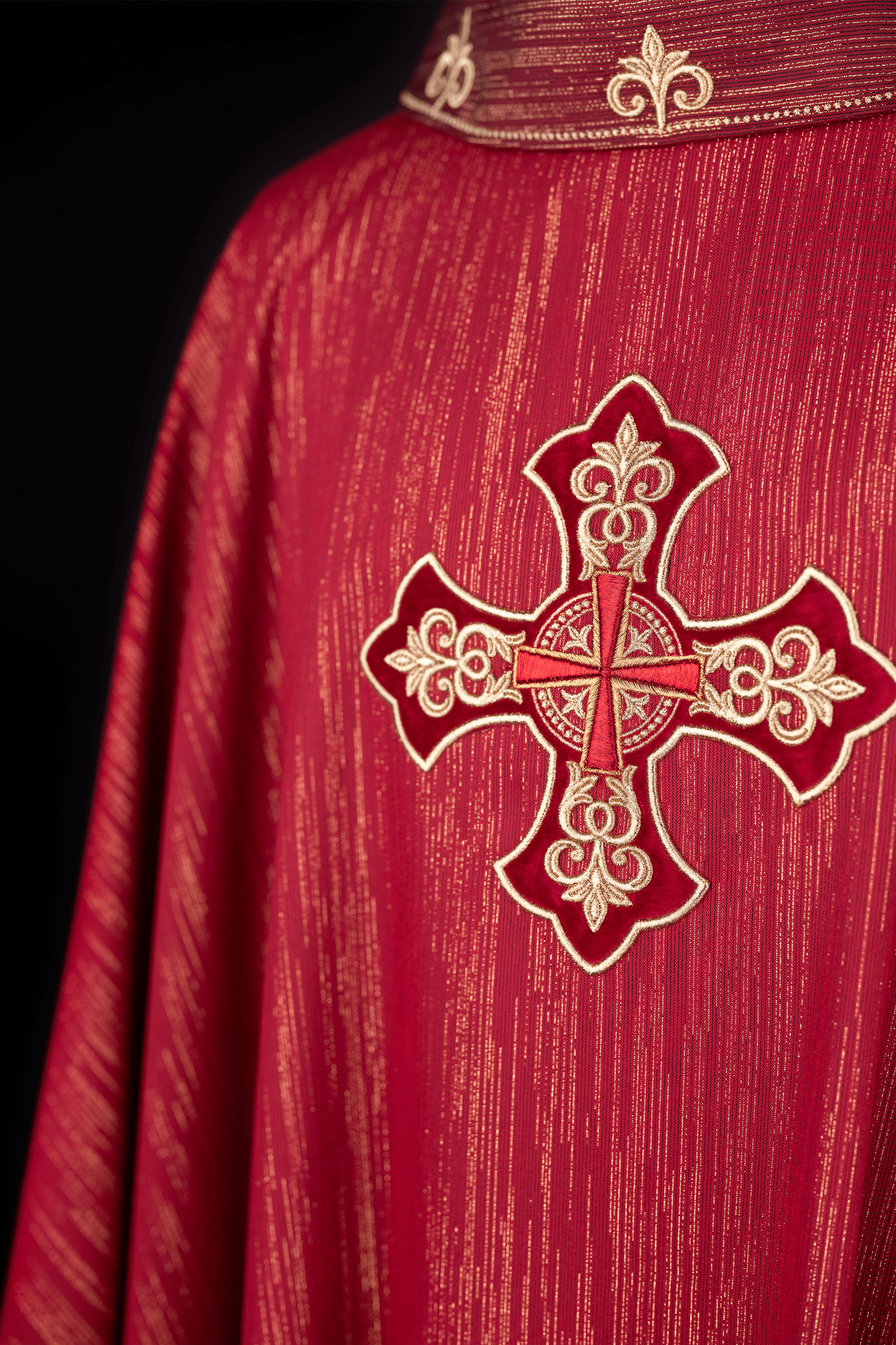 Red chasuble with richly embroidered cross and decorated collar