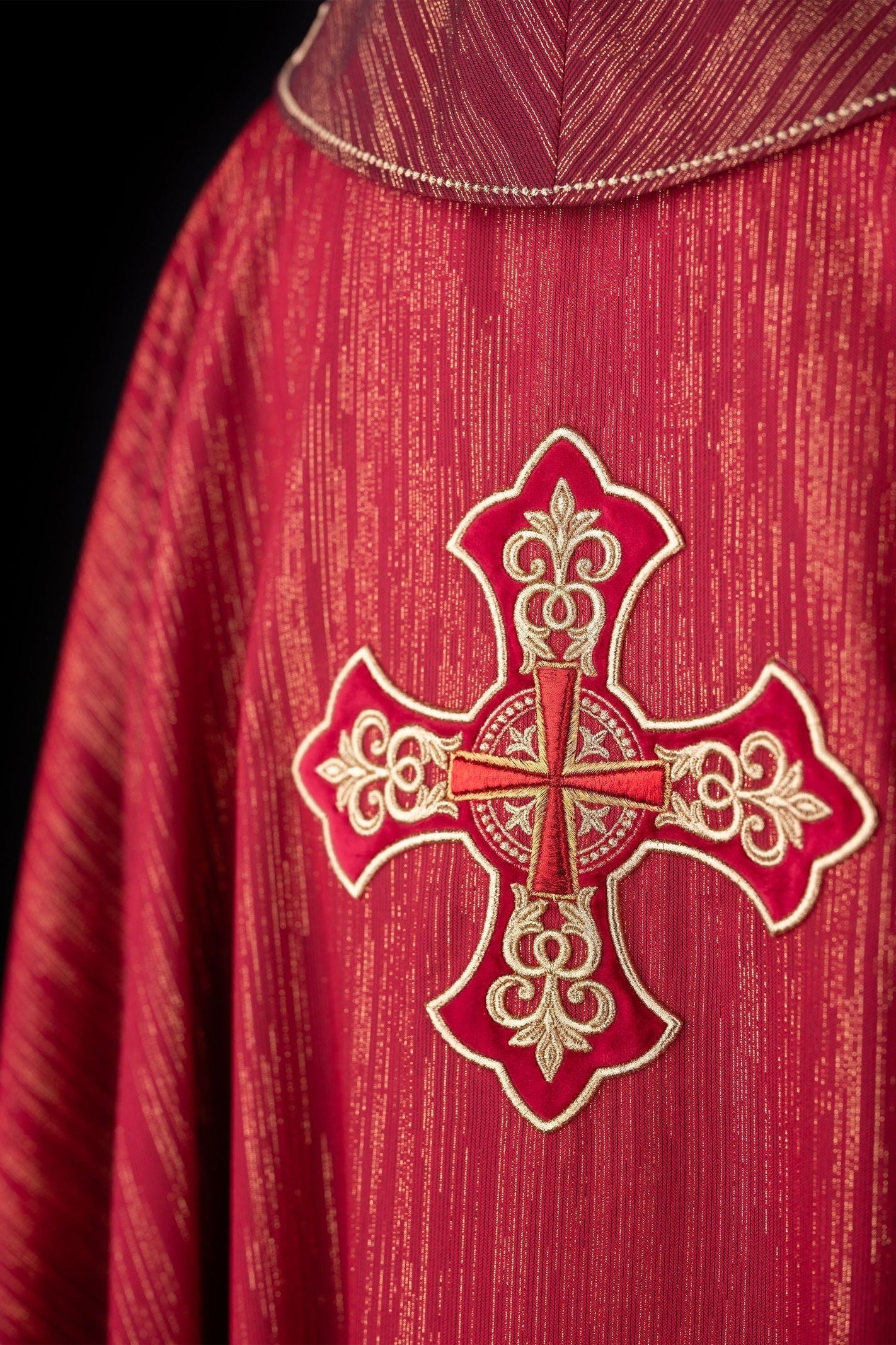 Red chasuble with richly embroidered cross and decorated collar