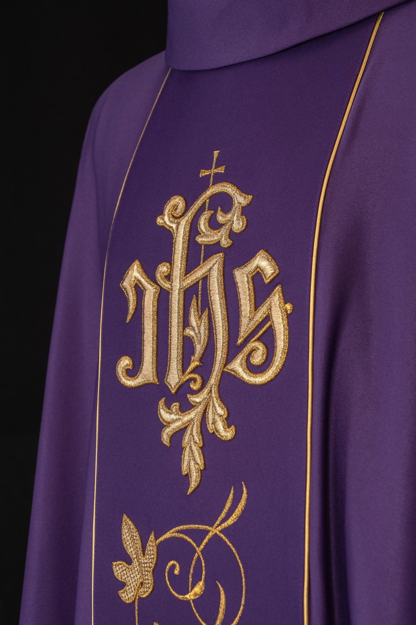 Purple liturgical chasuble with richly decorated belt with floral motif and IHS