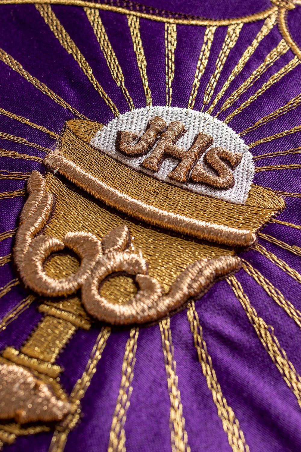 Purple cope with gold eucharist symbol