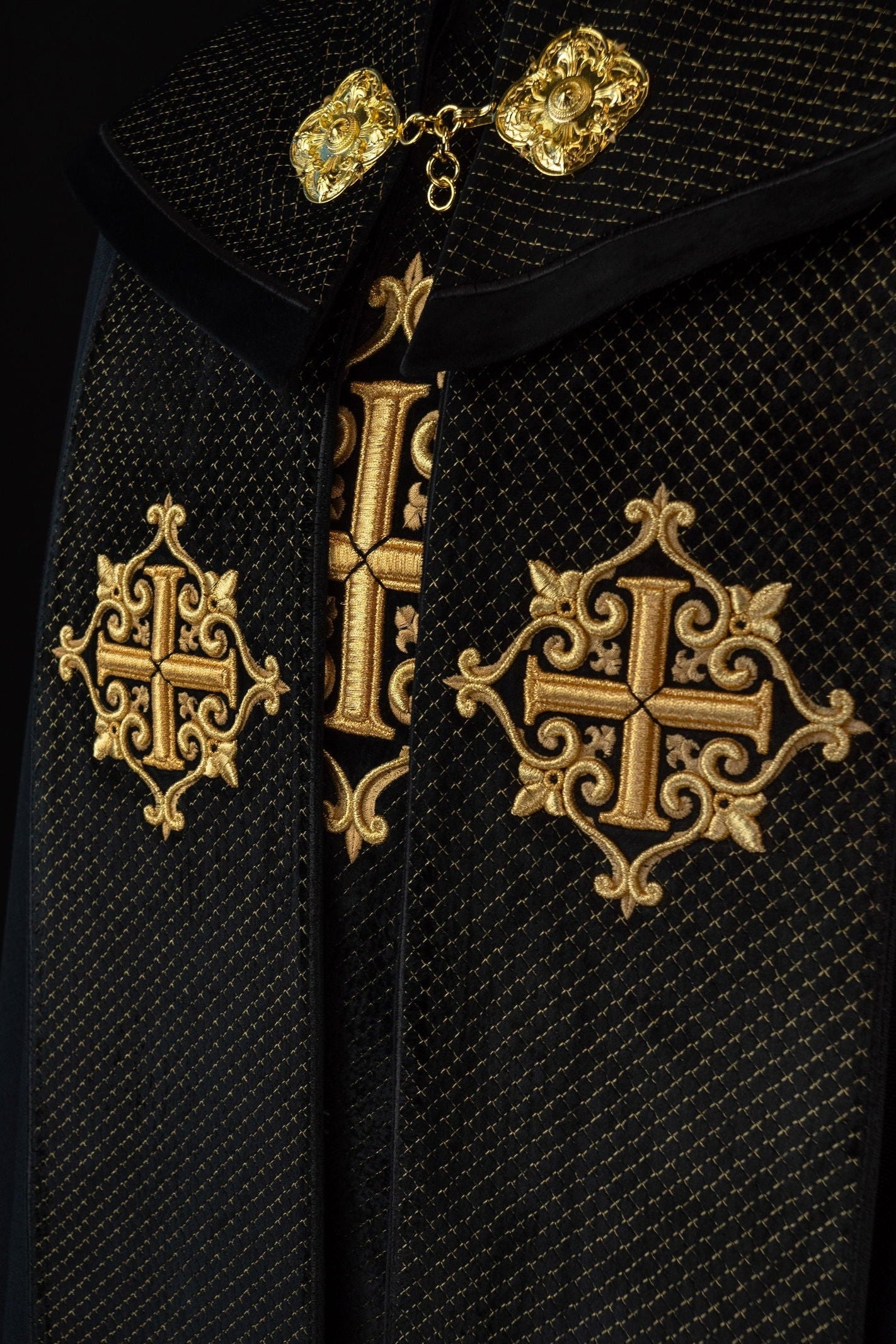 Black cope with a velvet sash and cross embroidery