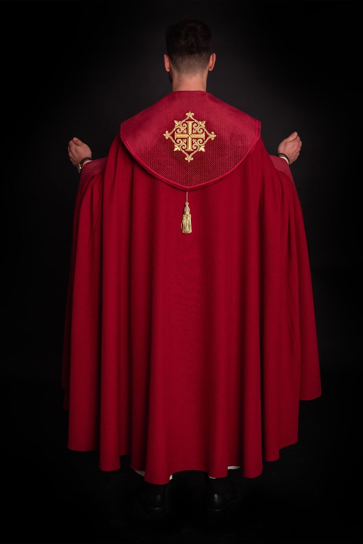 Red cope with a velvet sash and cross embroidery