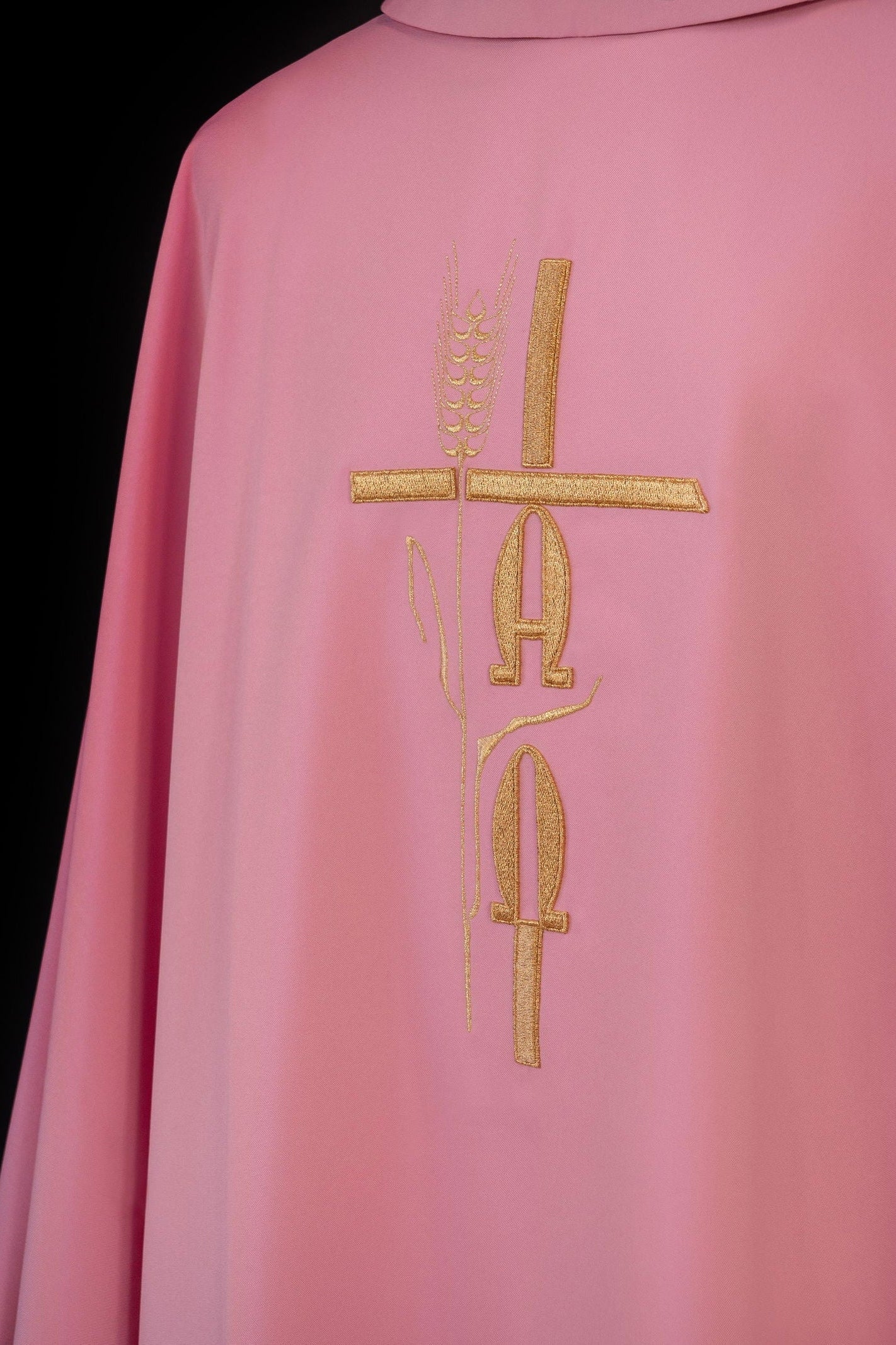 Pink chasuble with cross and alfa omega symbols