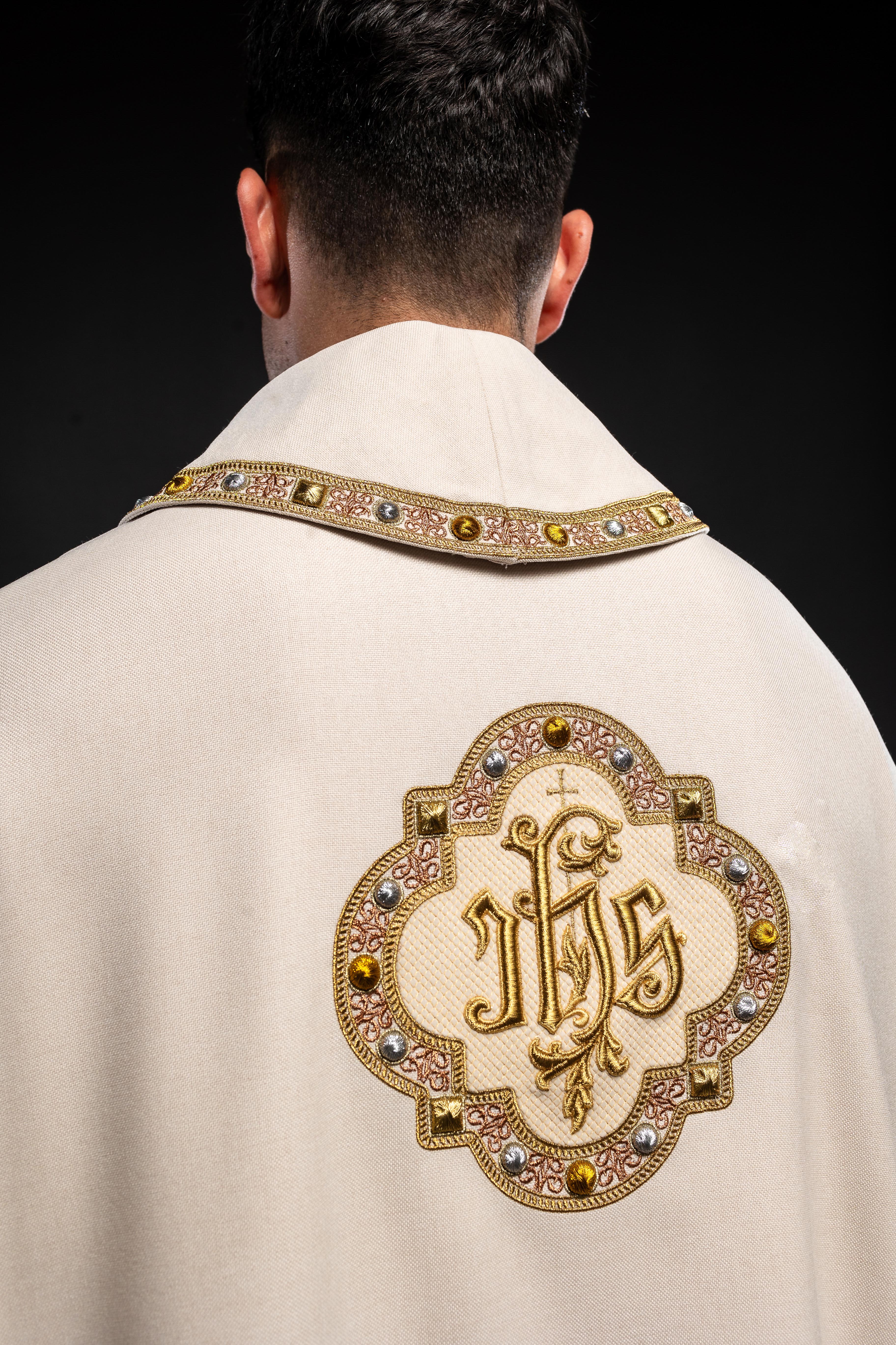 Cream colored chasuble with classic JHS symbol and colorful collar