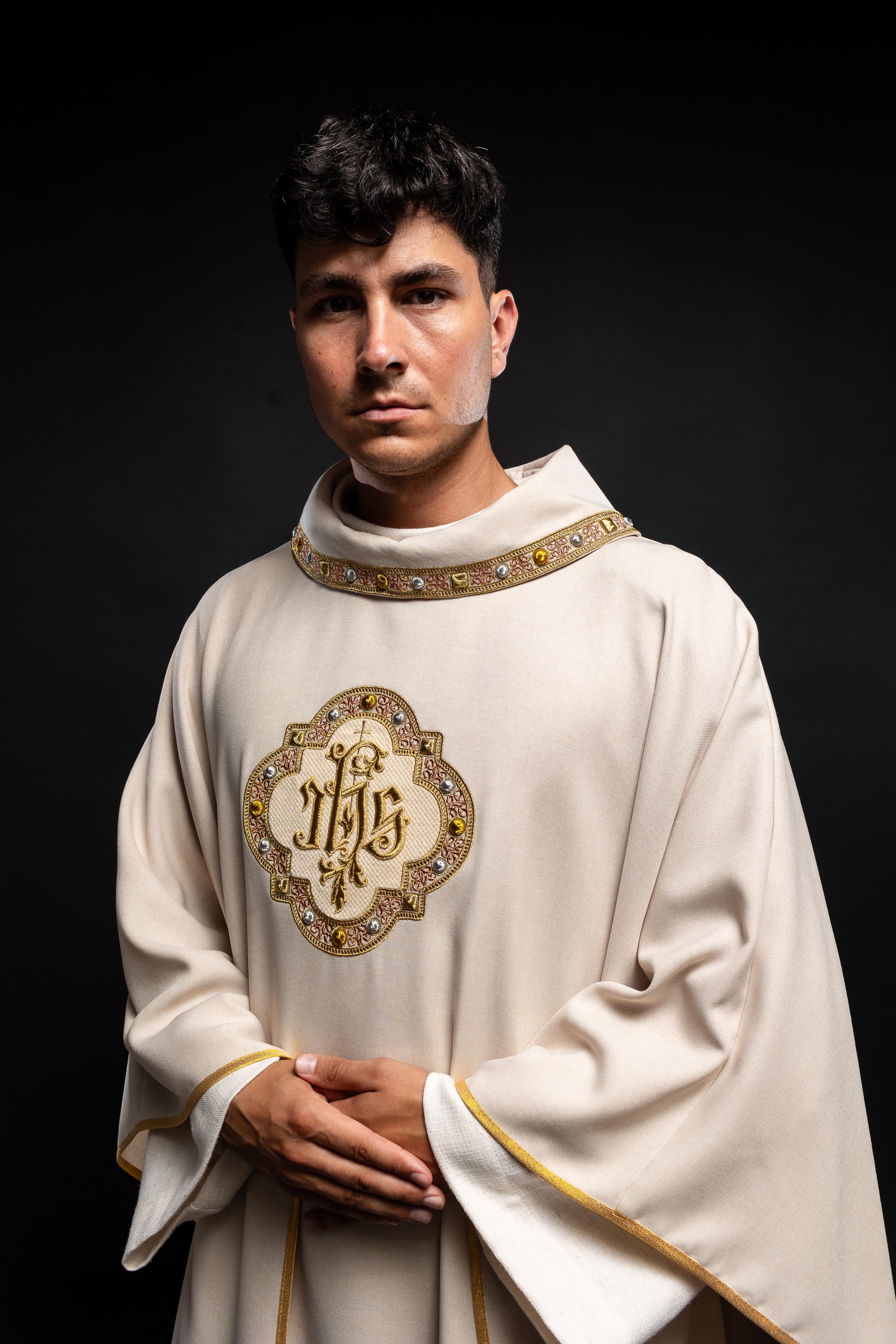 Cream colored chasuble with classic JHS symbol and colorful collar