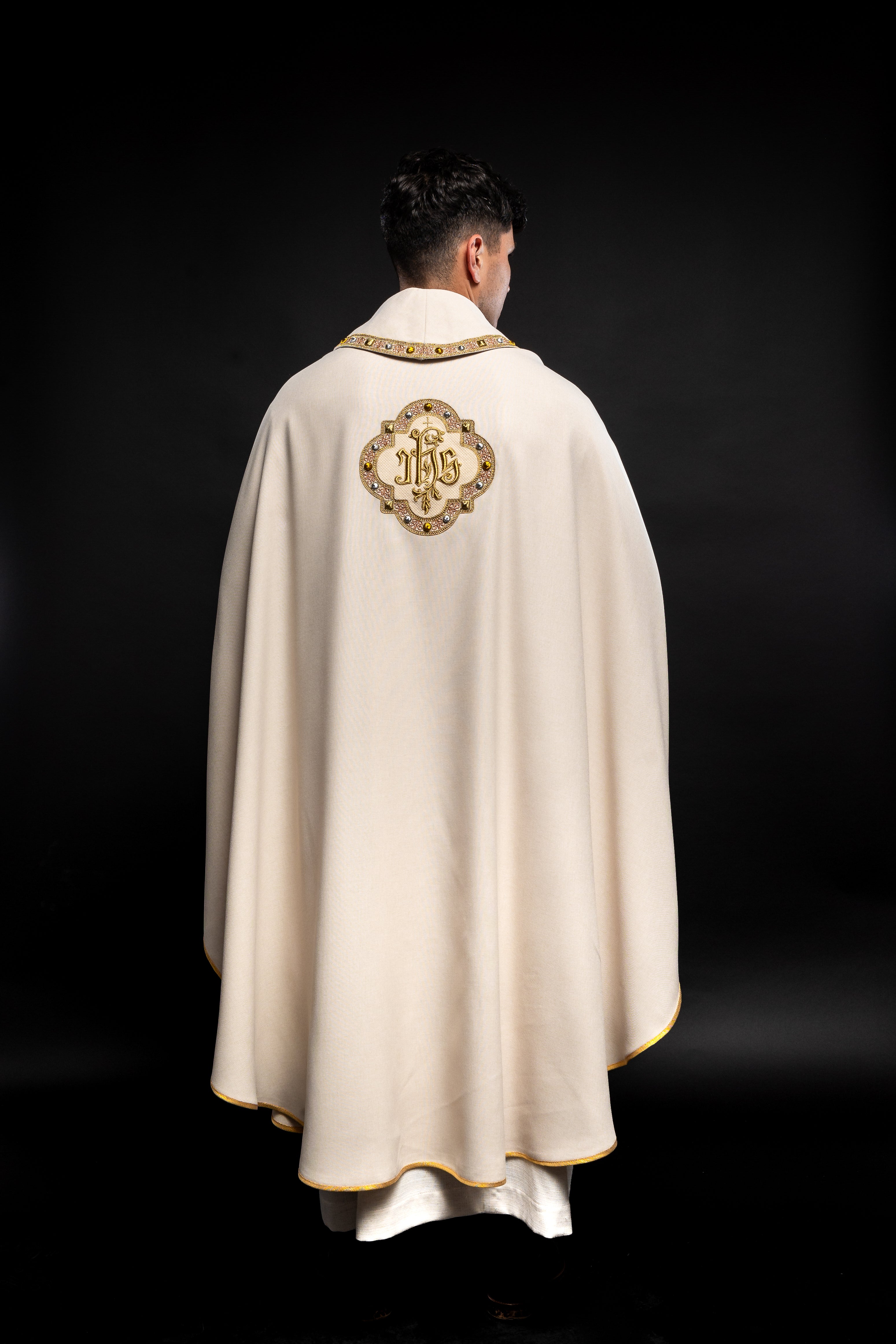 Cream colored chasuble with classic JHS symbol and colorful collar