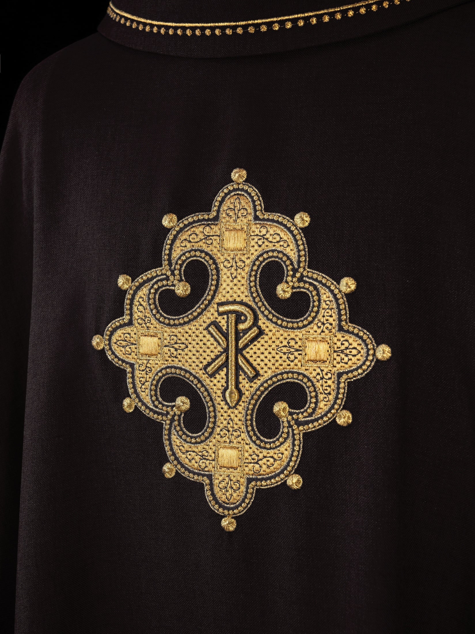 Black chasuble with gold PAX symbol