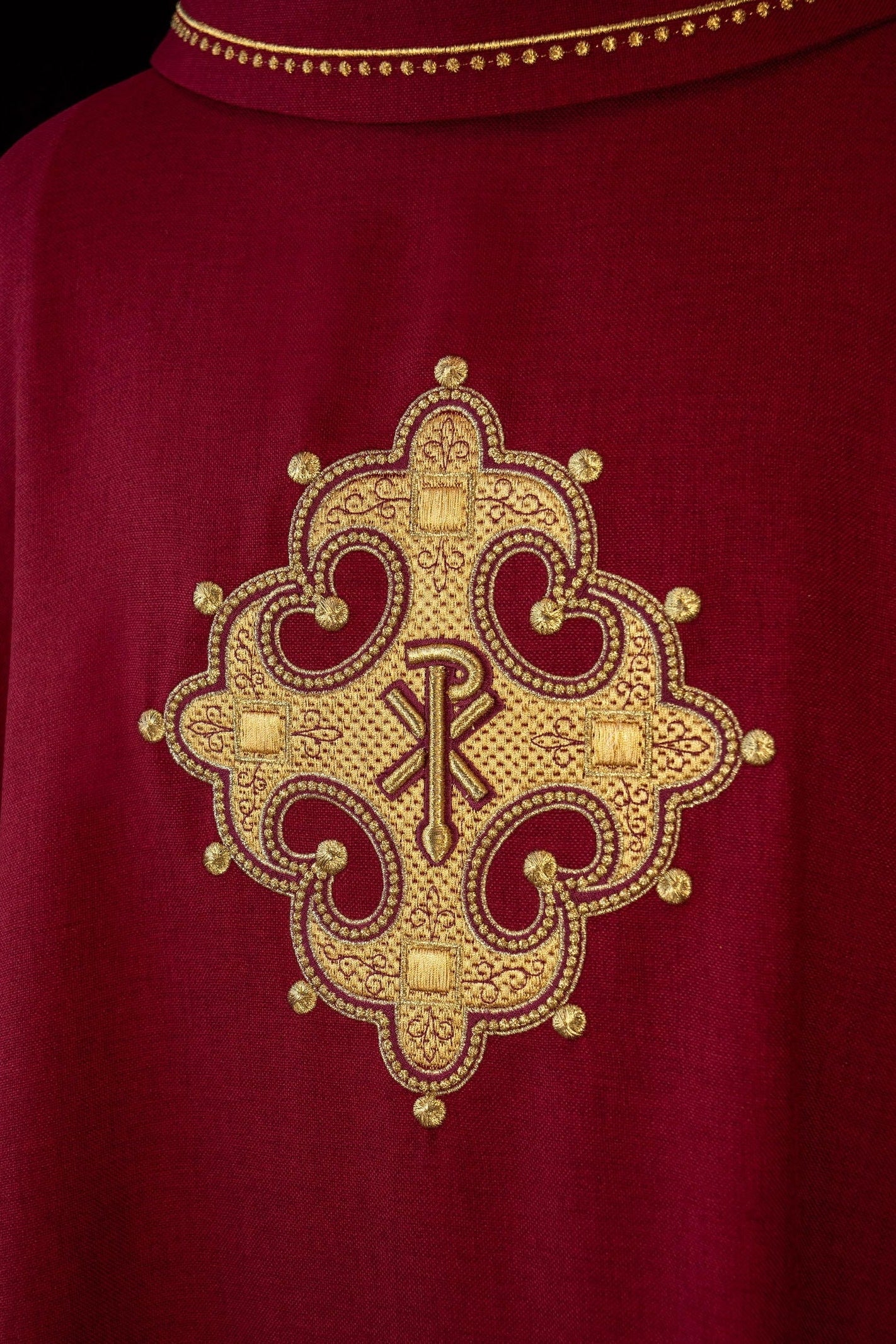 Chasuble with embroidered cross and gold trim on collar in red